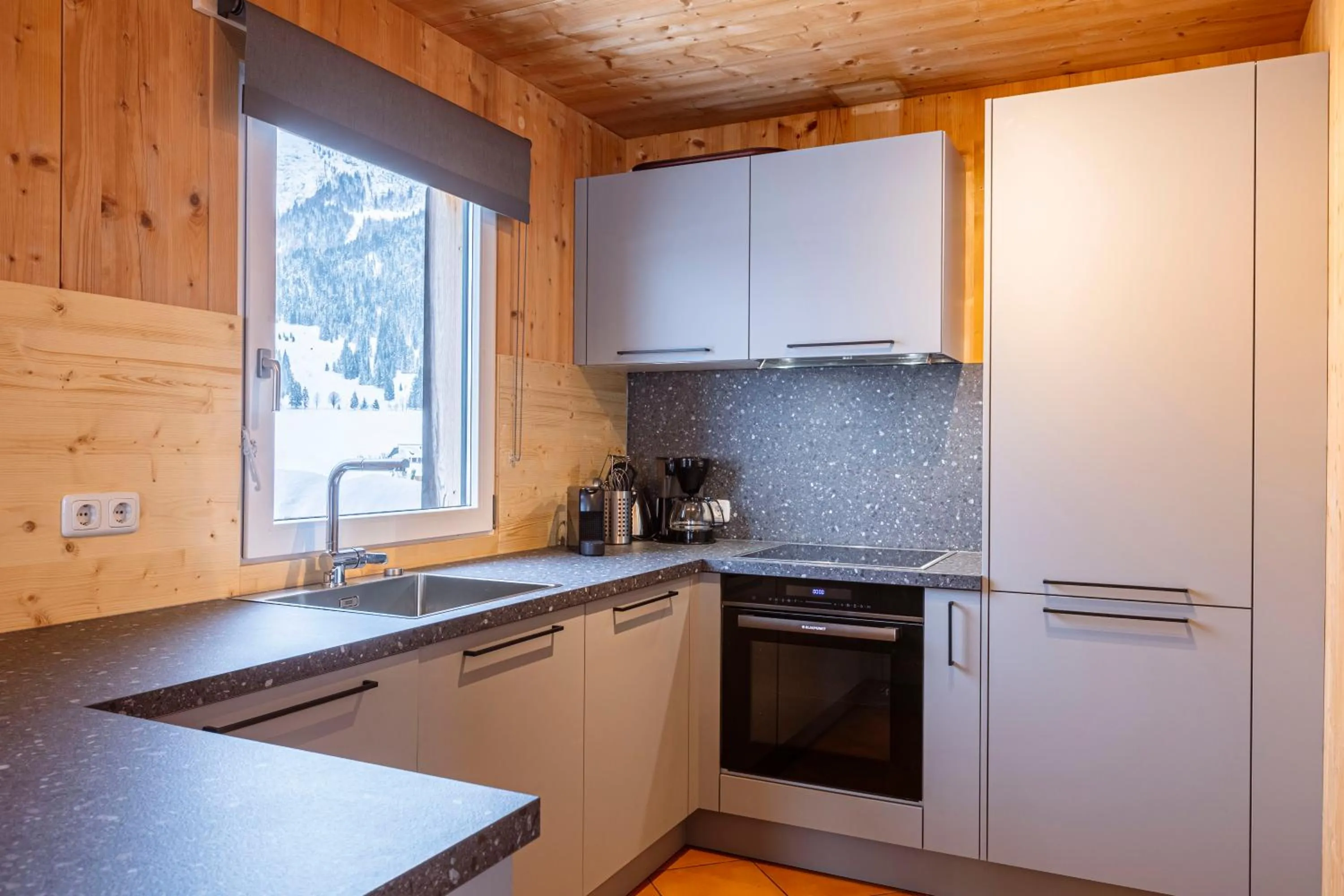 kitchen in Alpendorf Dachstein West by ALPS RESORTS