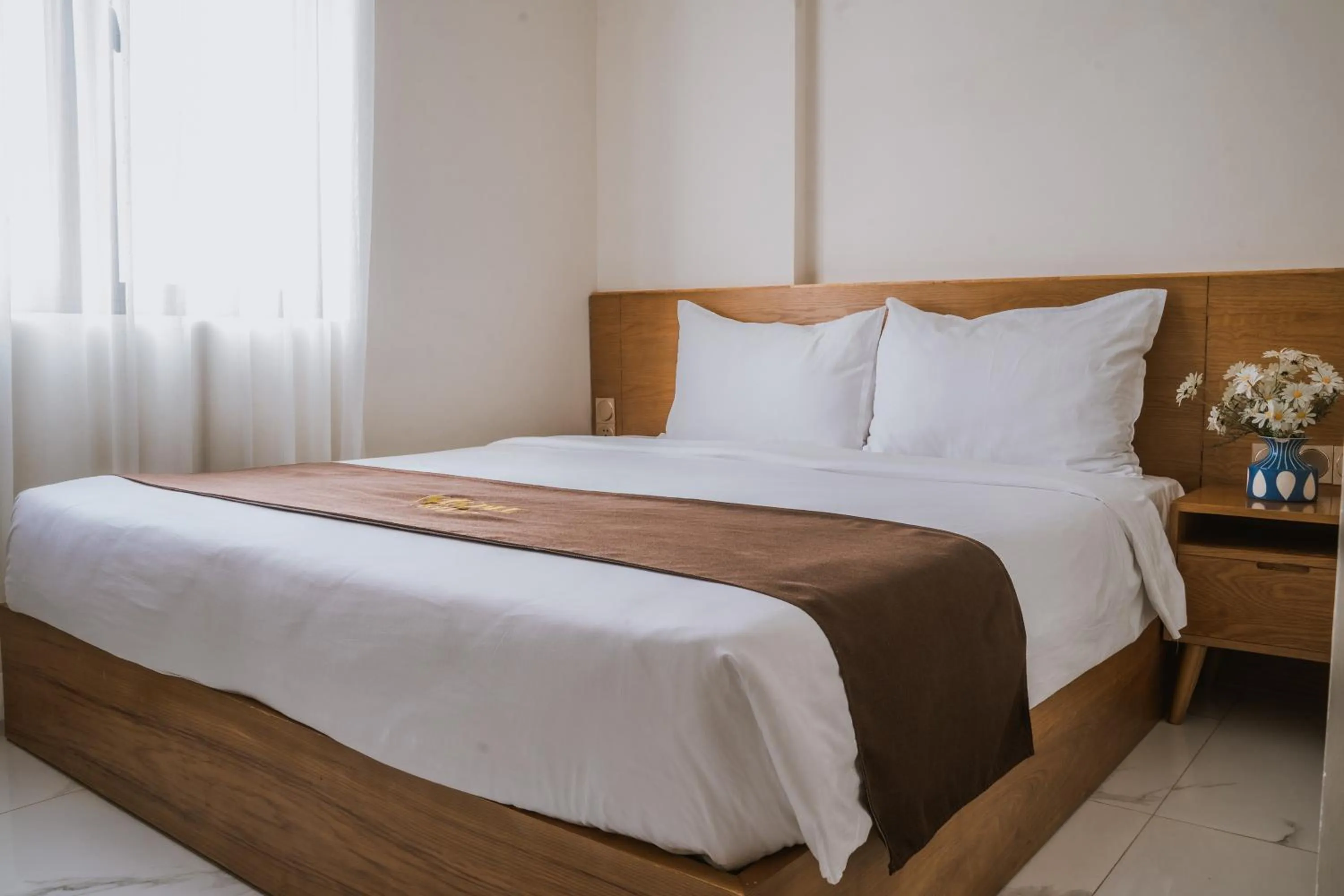 Bed in Maple Suite Hotel & Apartment