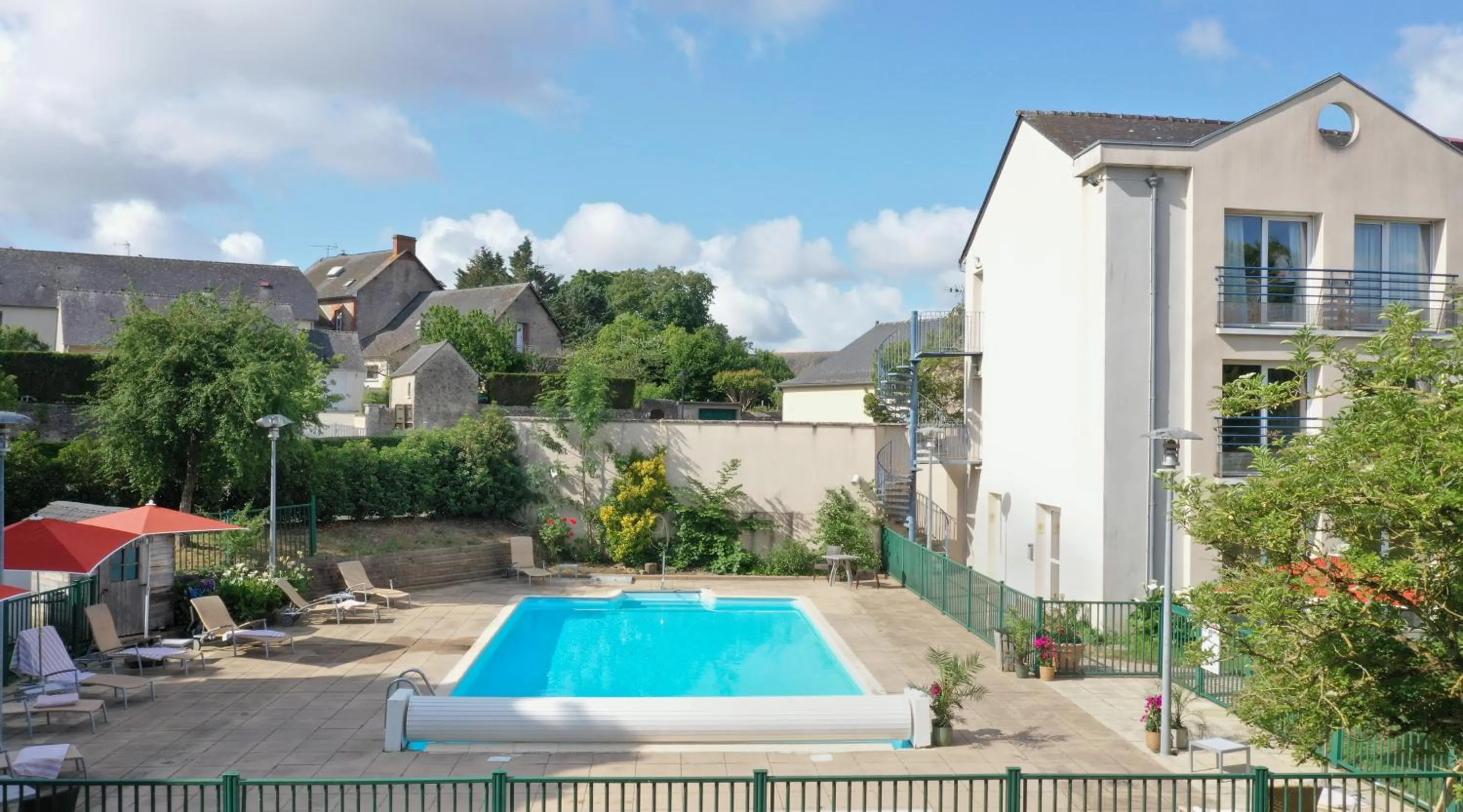 Swimming pool in Logis Hôtel & Restaurant L'ermitage