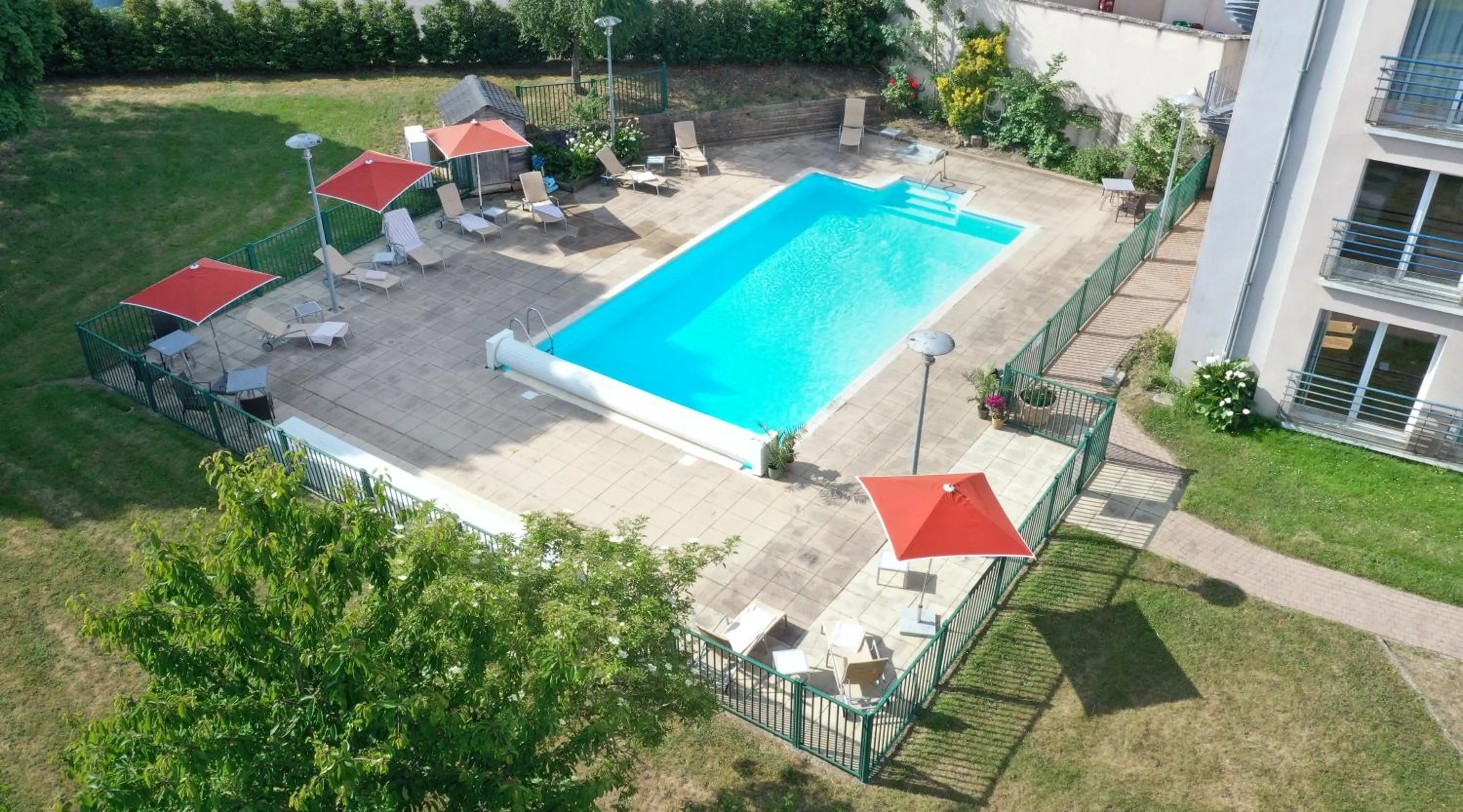 Swimming pool in Logis Hôtel & Restaurant L'ermitage