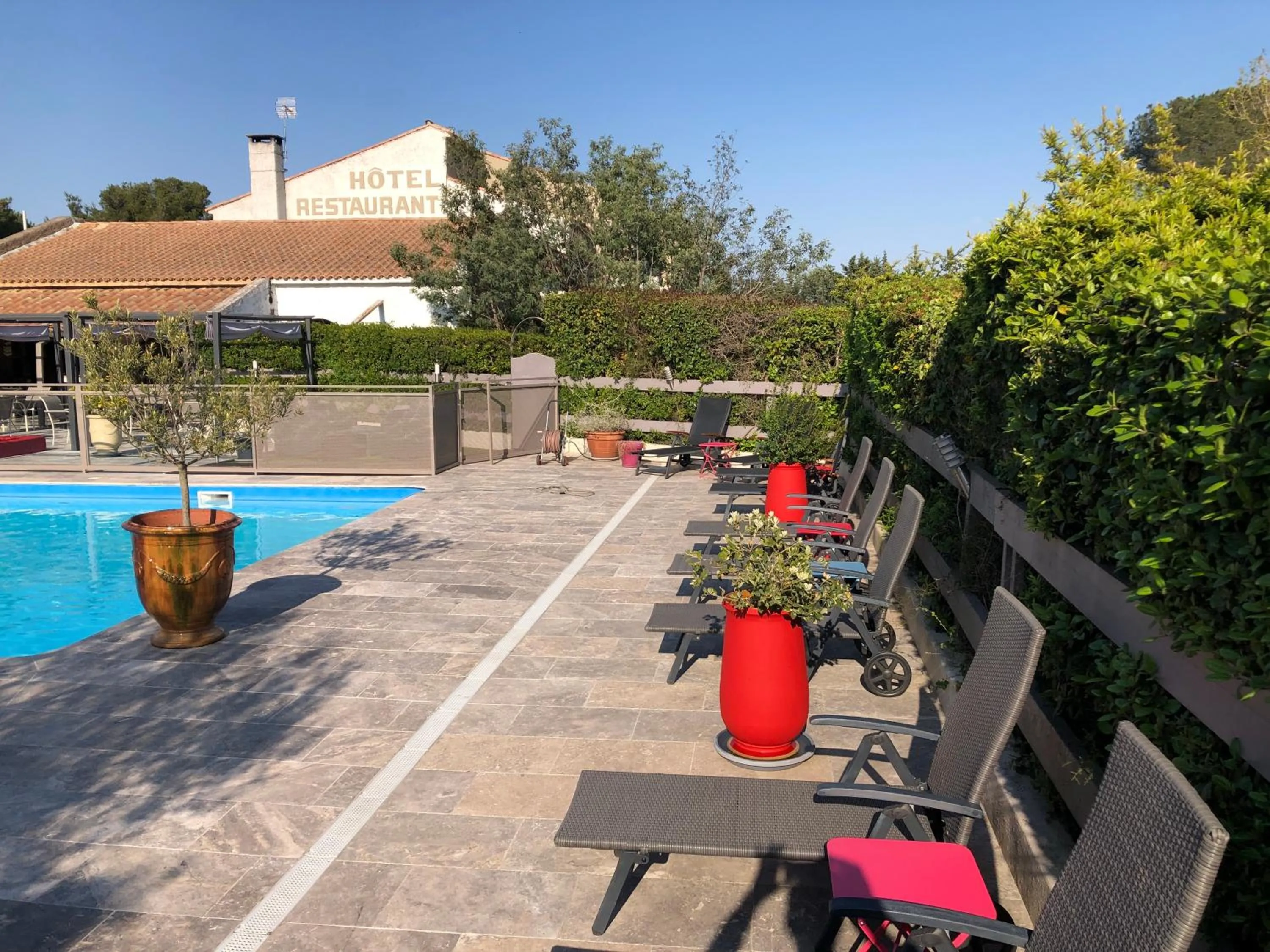 Swimming pool in Logis Hôtel Restaurant Les Aubuns