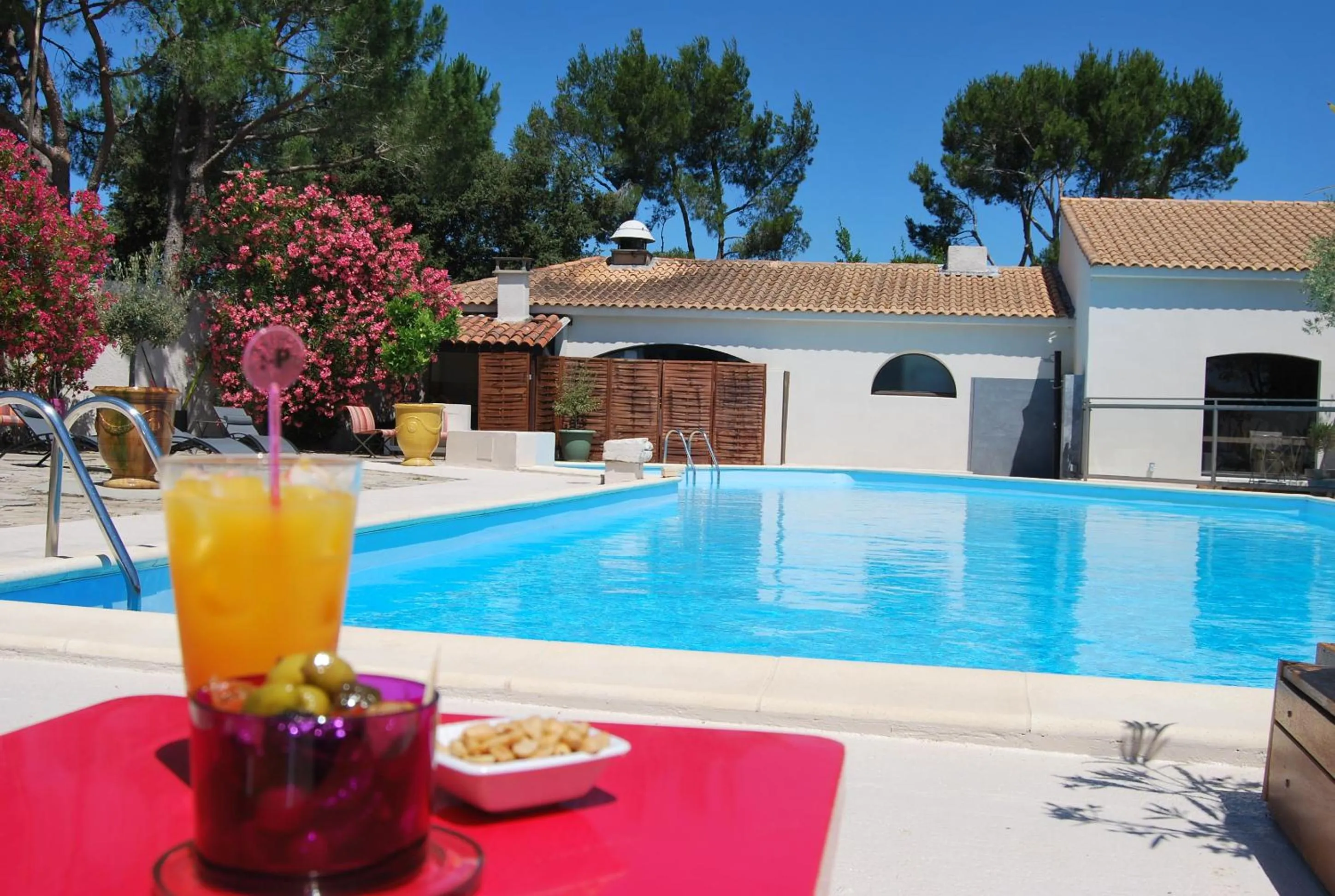 Swimming pool in Logis Hôtel Restaurant Les Aubuns