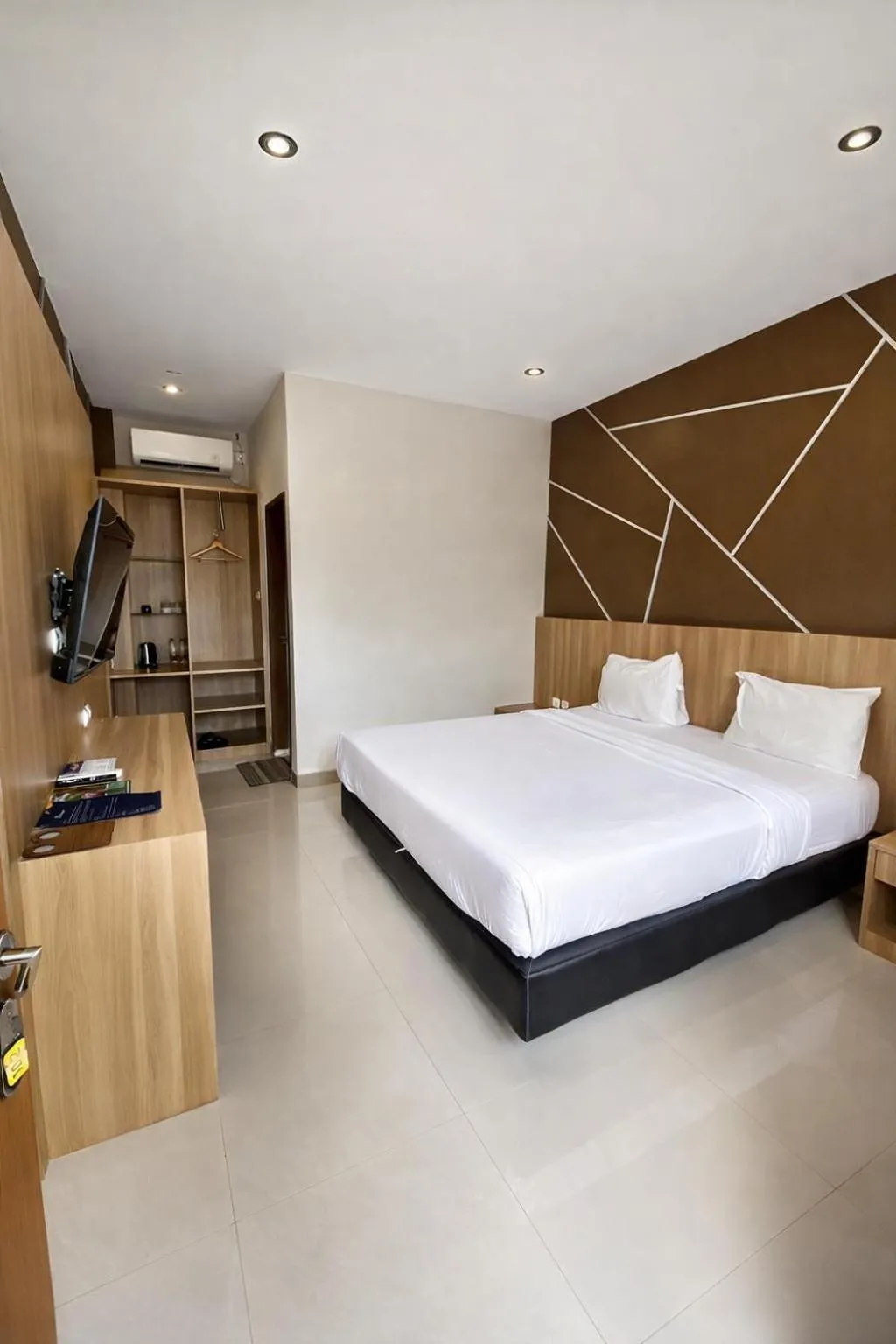 Bed in Grand Kuta Hotel Lombok - Pool - 43 inch Google TV - Strong 60Mbps WiFi - New Enhanced Management