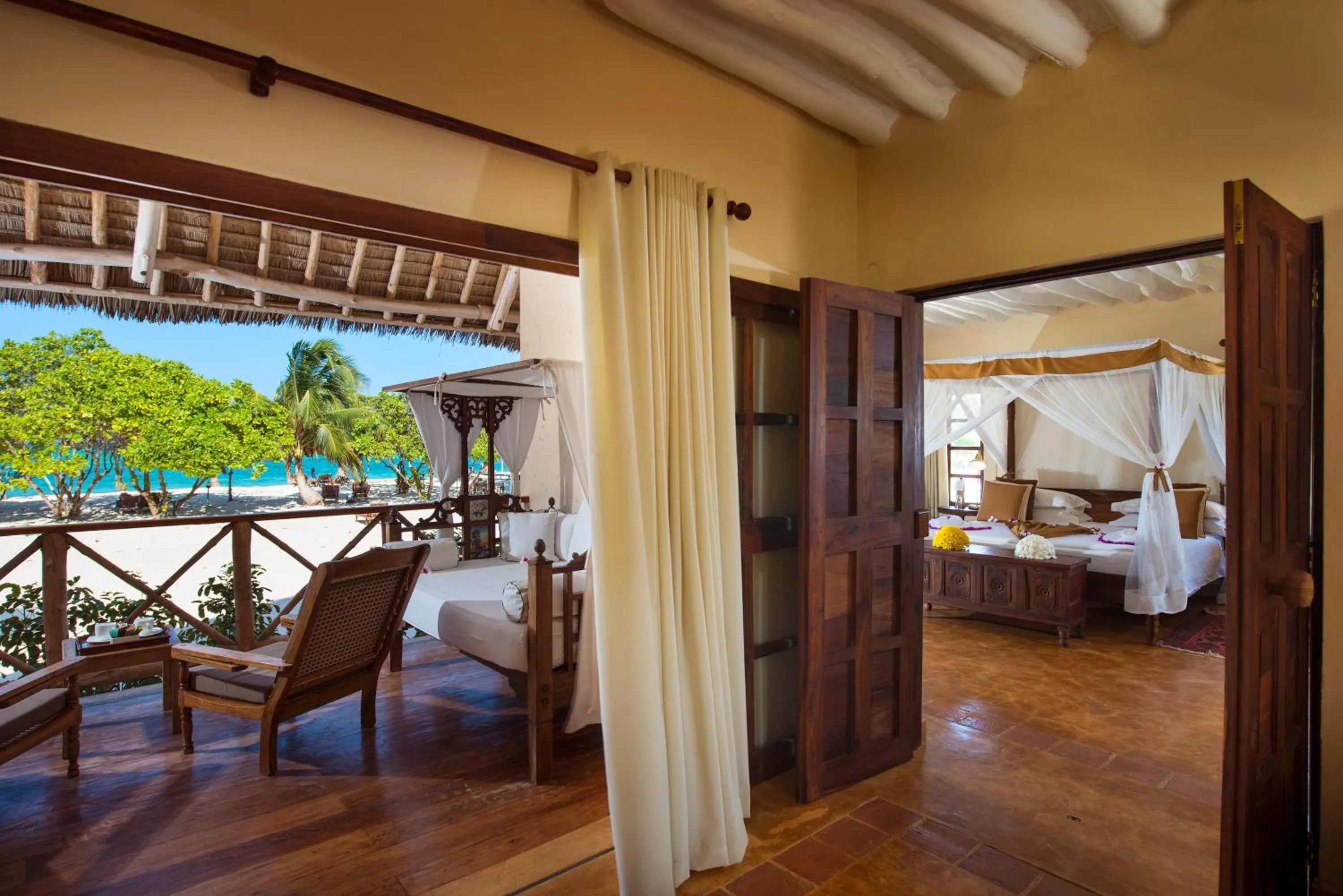 Balcony/Terrace, Bed in Neptune Pwani Beach Resort & Spa Zanzibar - All Inclusive