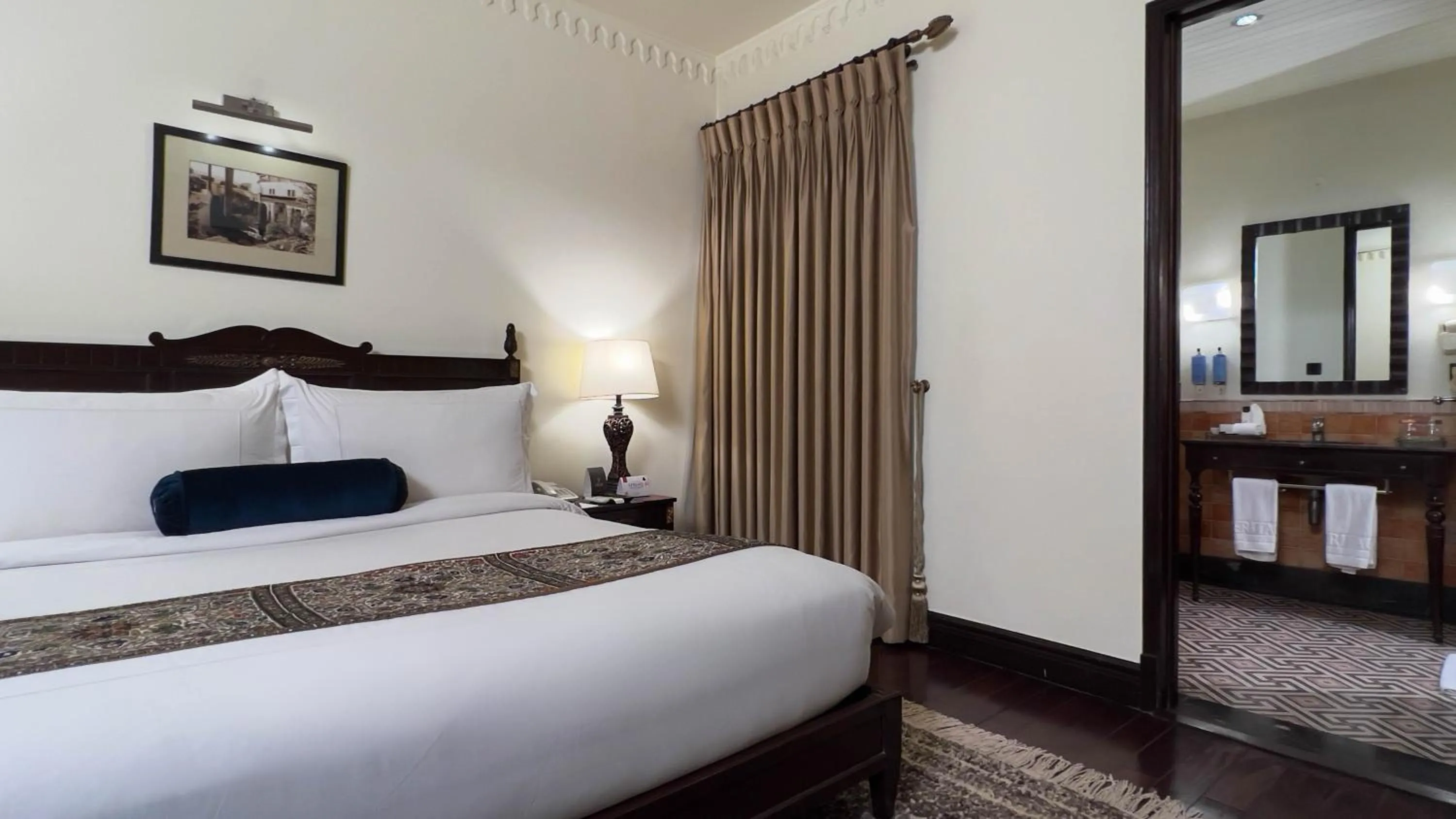 Bed in Heritage Luxury Suites All Suite Hotel