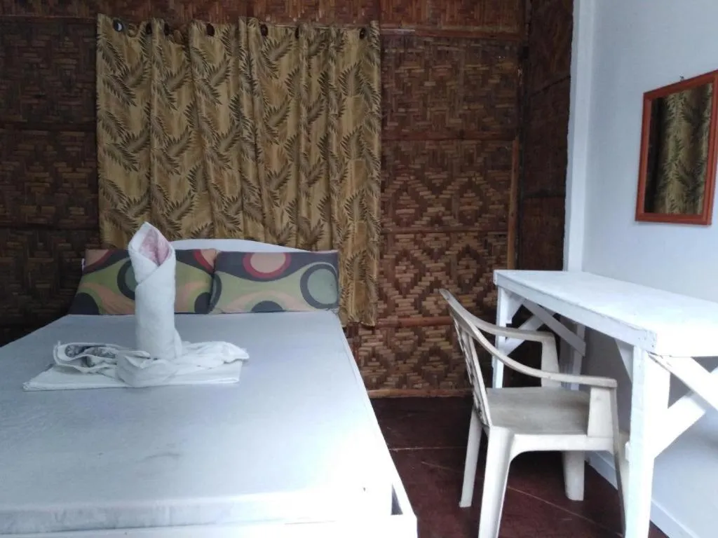 Bed in The Shark's Tail Dive Resort