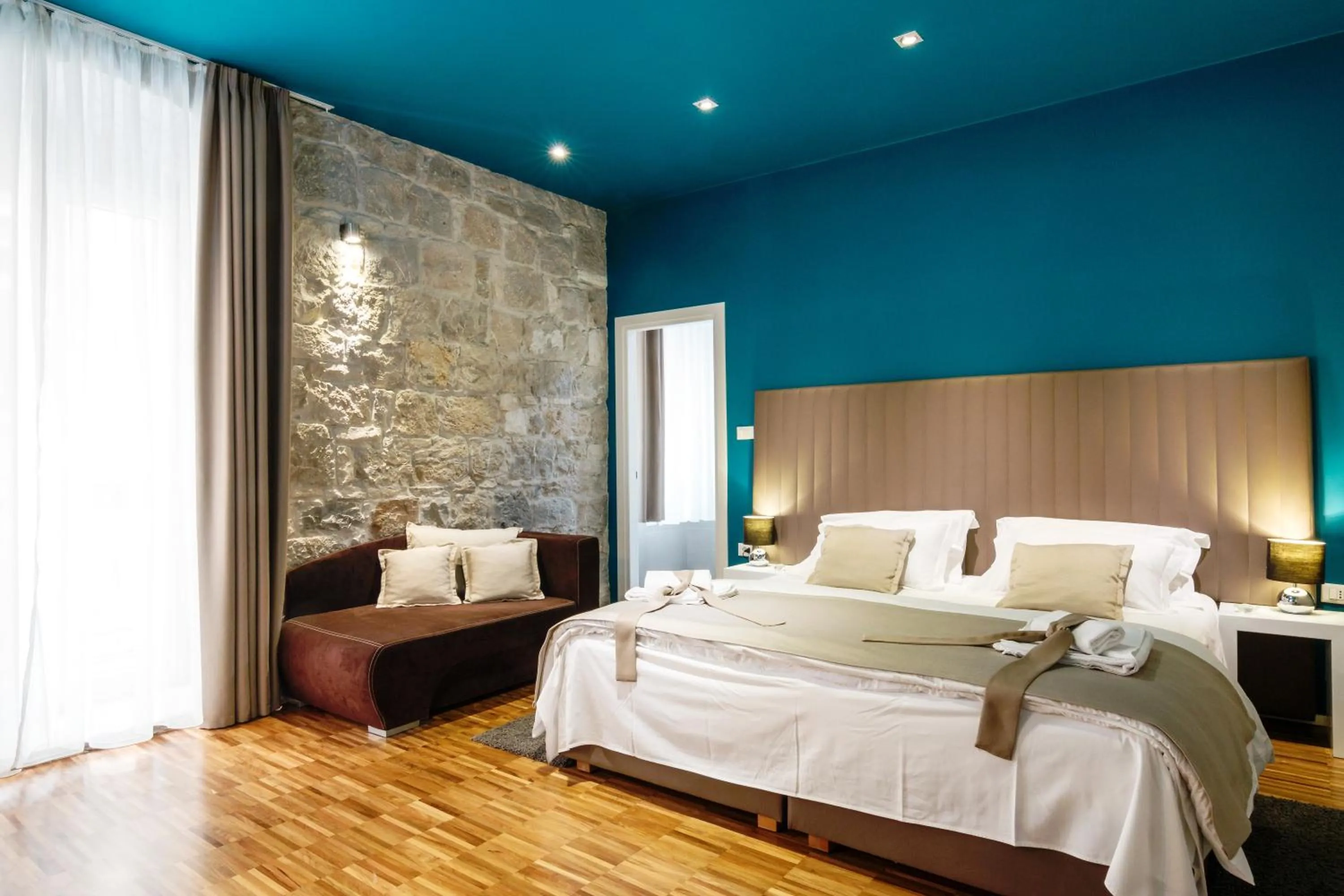 Bed in Riva Luxury Rooms