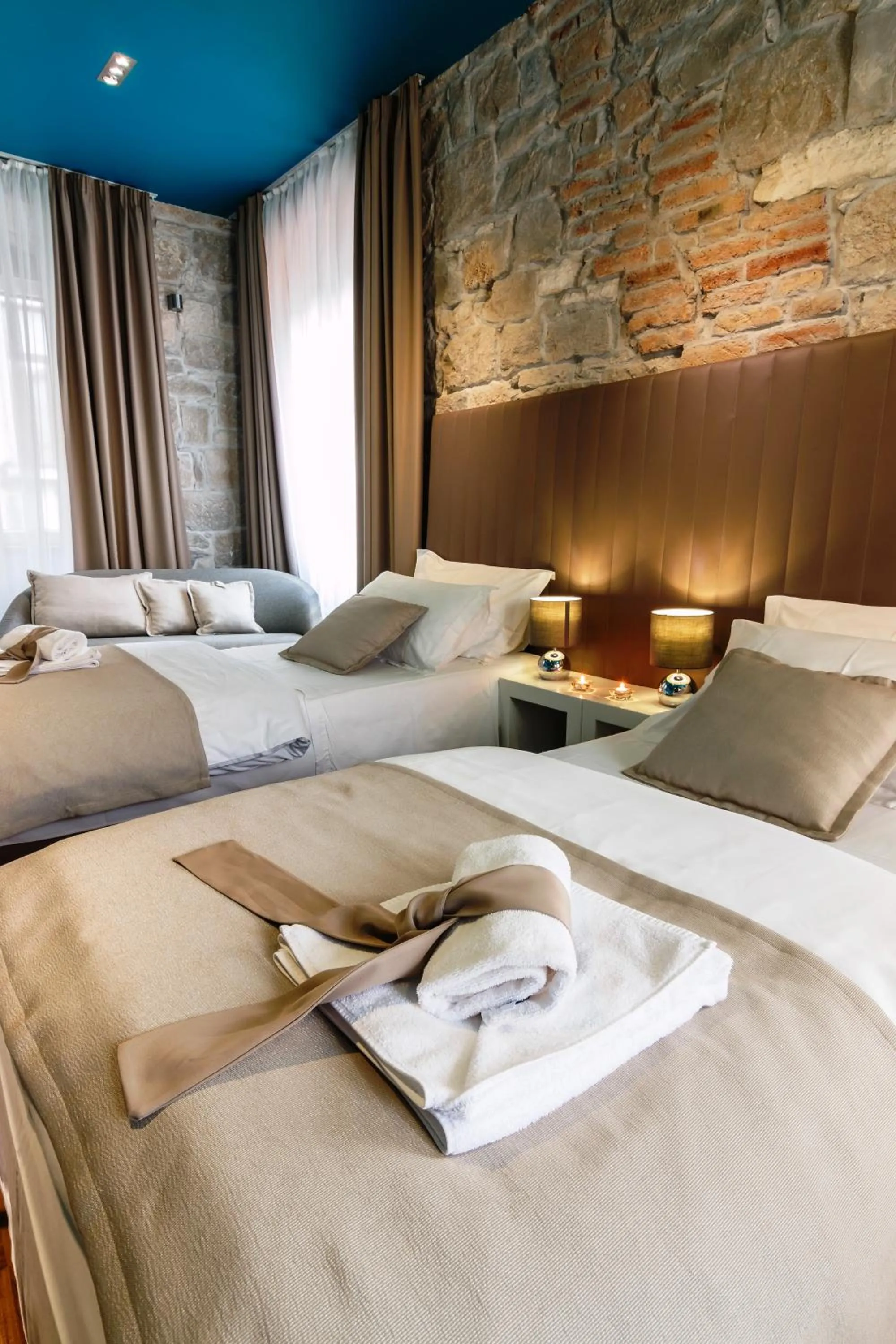 Bed in Riva Luxury Rooms