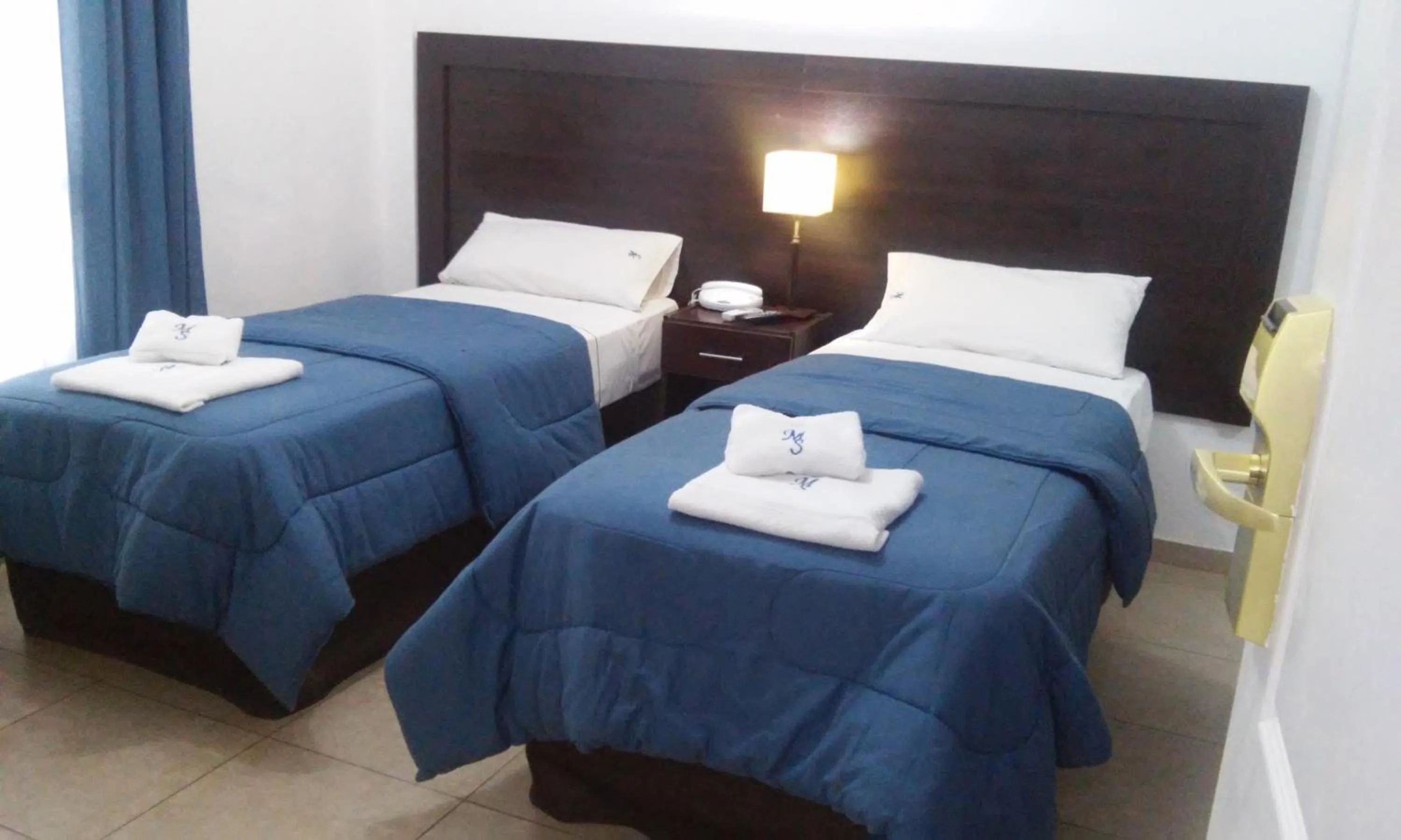 Bed in Morada Suites