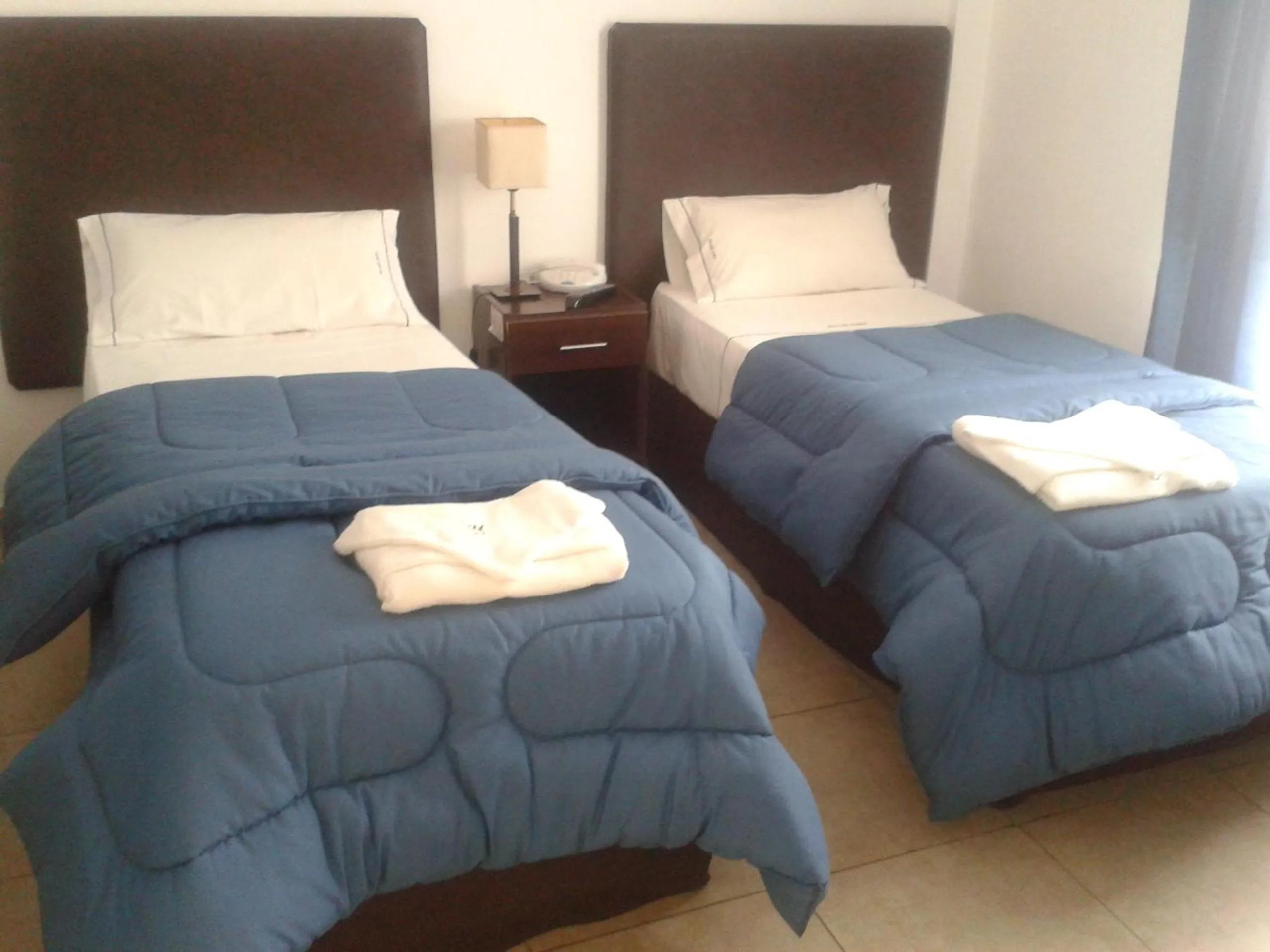 Bed in Morada Suites