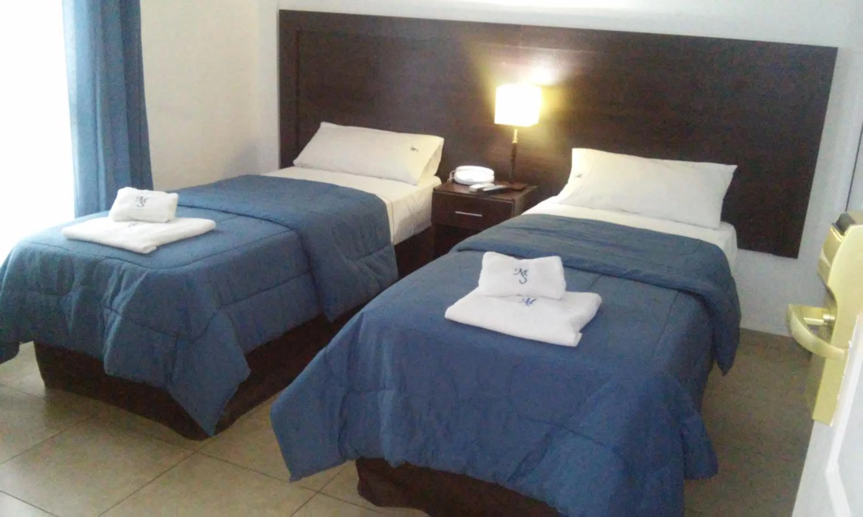 Bed in Morada Suites