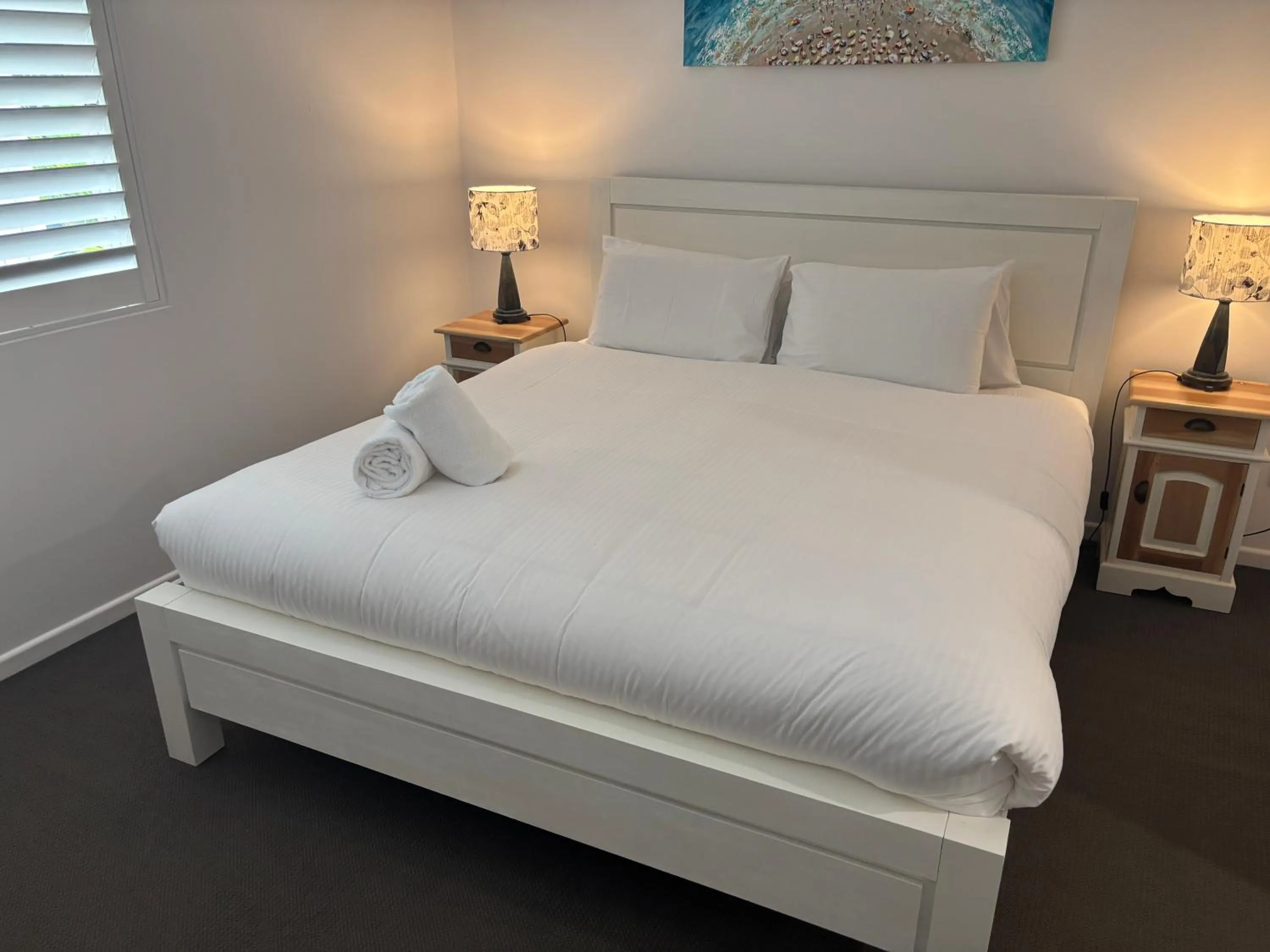 Bed in Aqua Promenade Beachfront Holiday Apartments