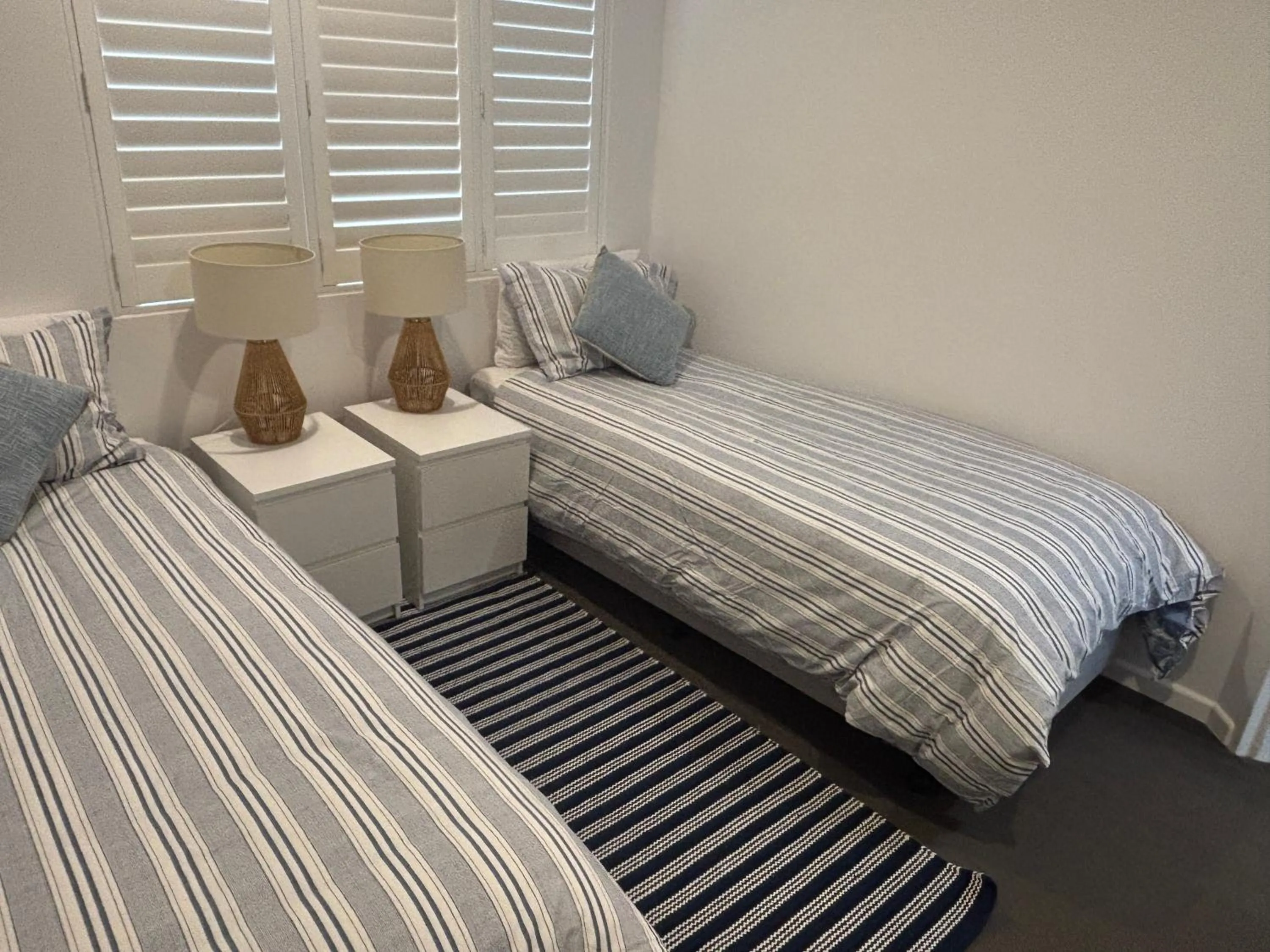 Bed in Aqua Promenade Beachfront Holiday Apartments