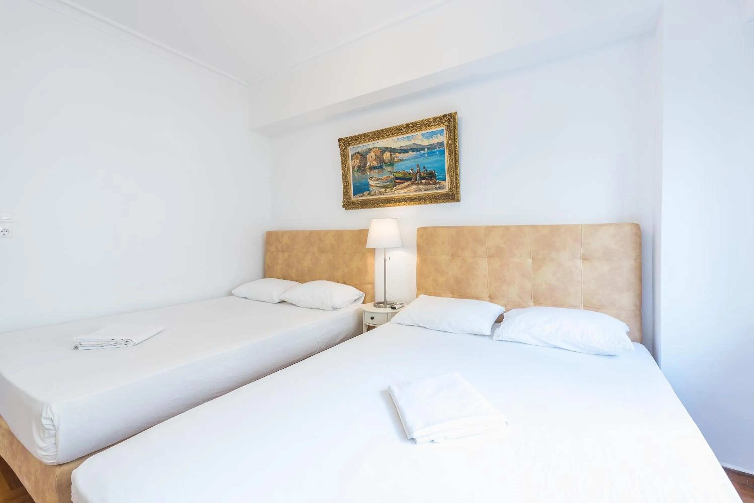 Bed in Victoria Queens Suites Apartments