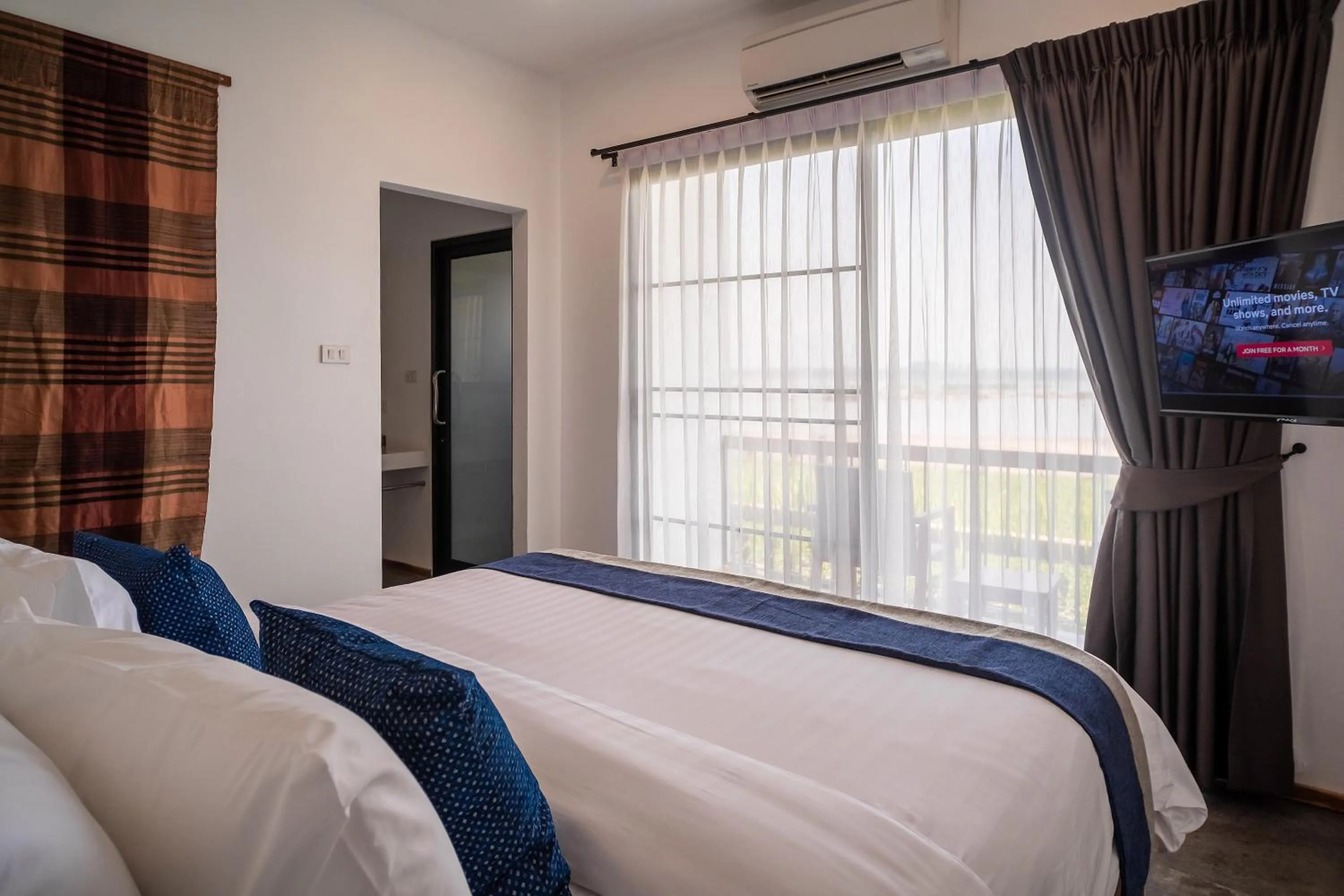 Bed in The Riviera Champasak