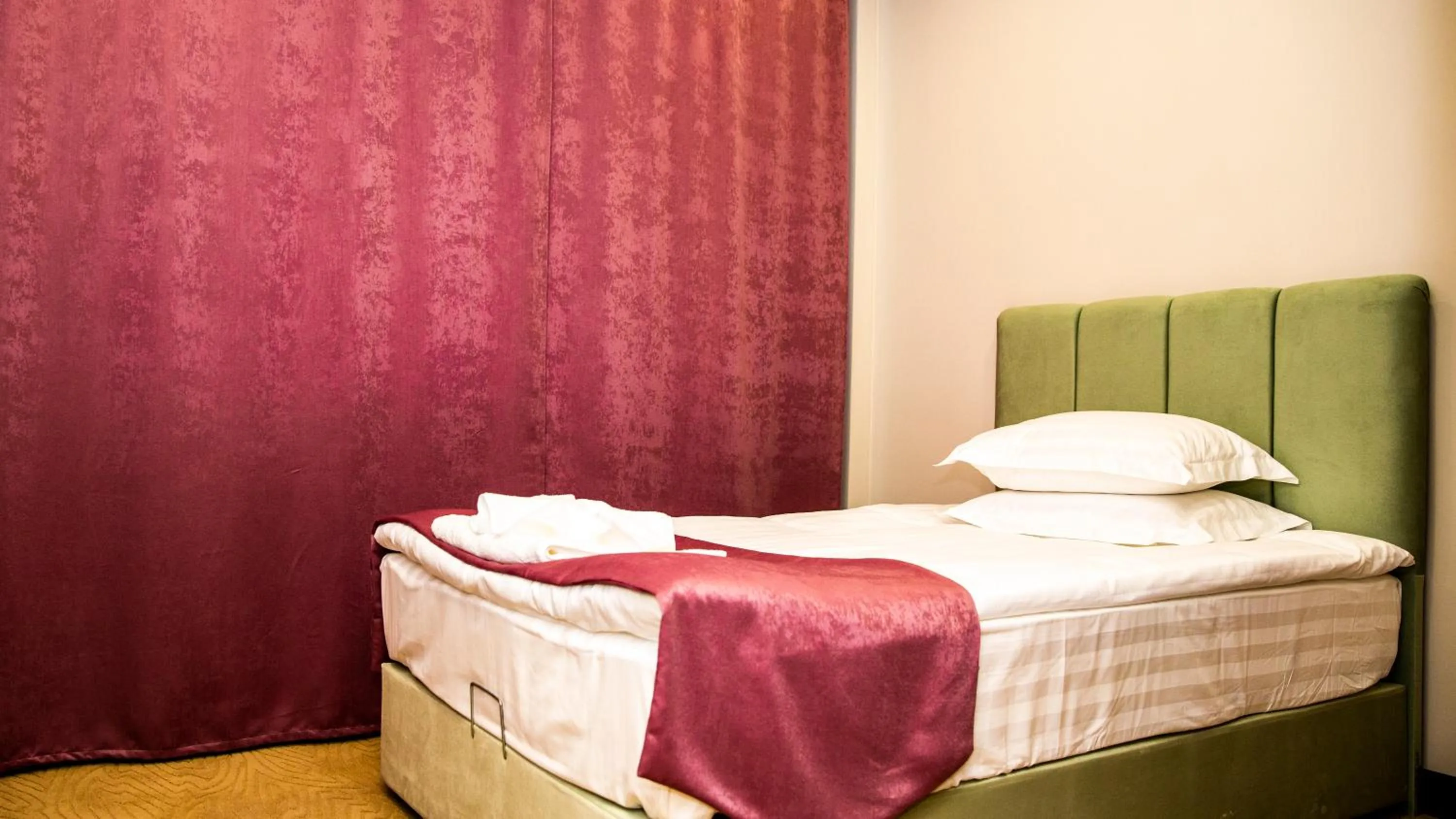 Bed in SULO Atyrau Hotel
