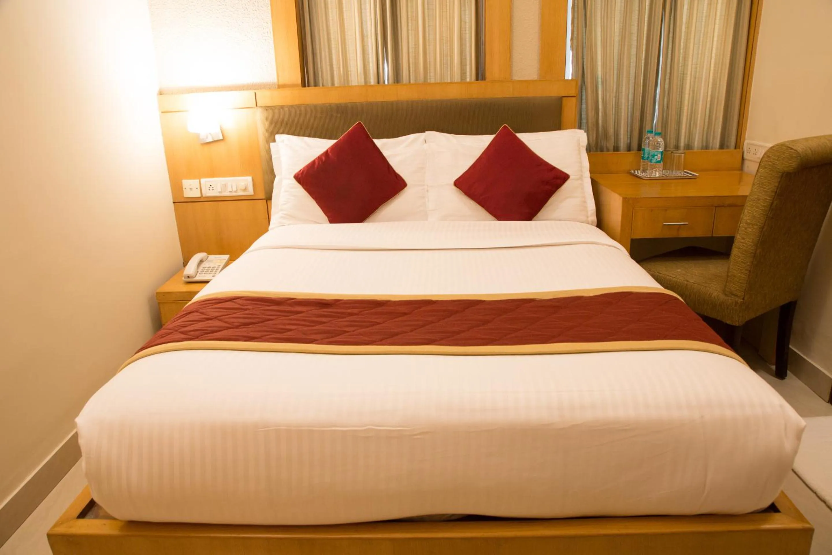 Bed in New Rainbow Business Hotel