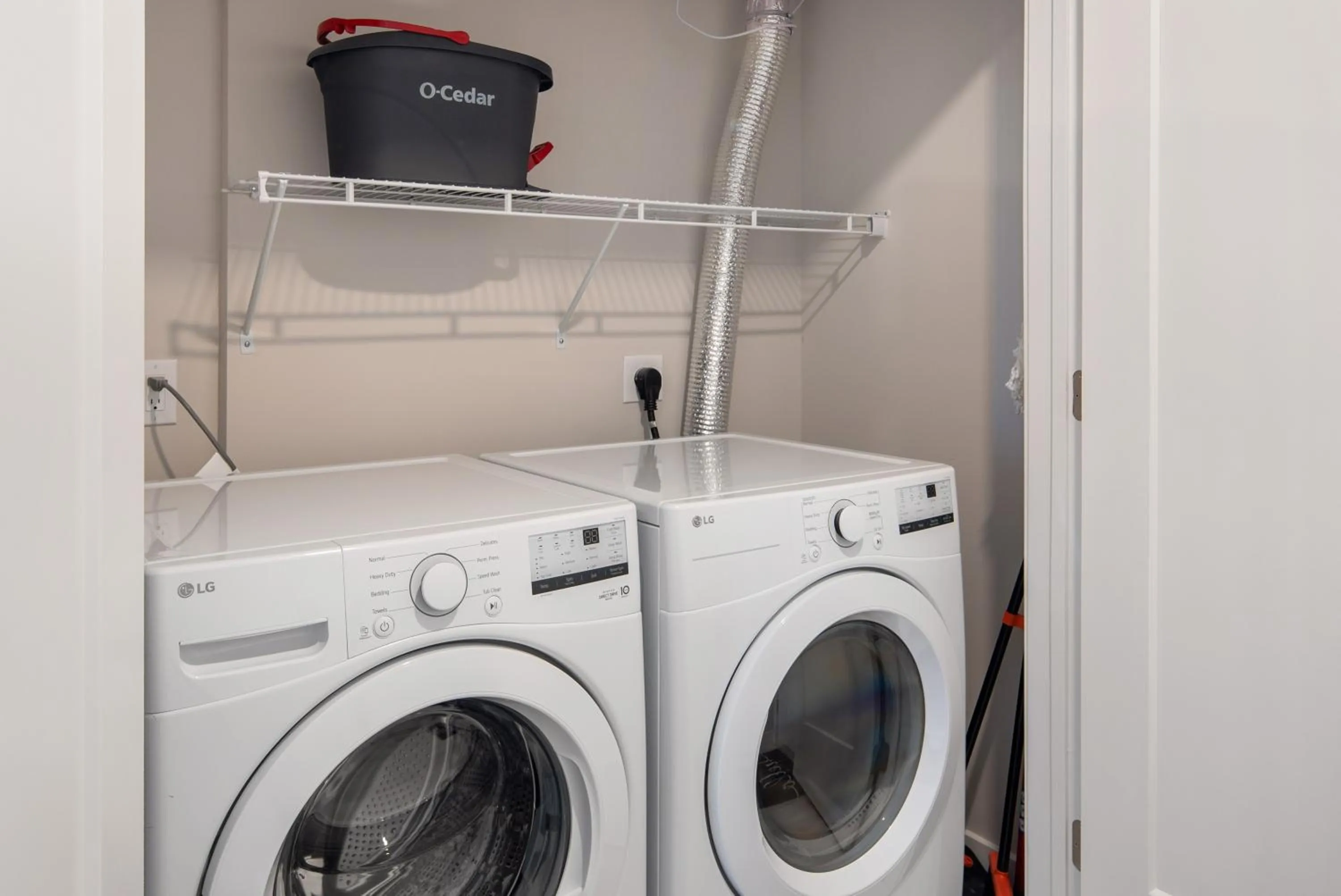 washing machine in Luxury Furnished Apartments by Hyatus Downtown at Yale