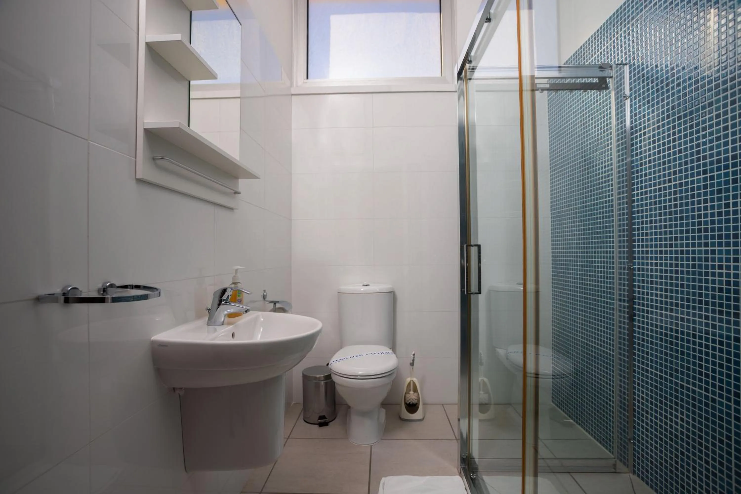 Bathroom in Athenaeum Beachside Apt by TrulyCyprus