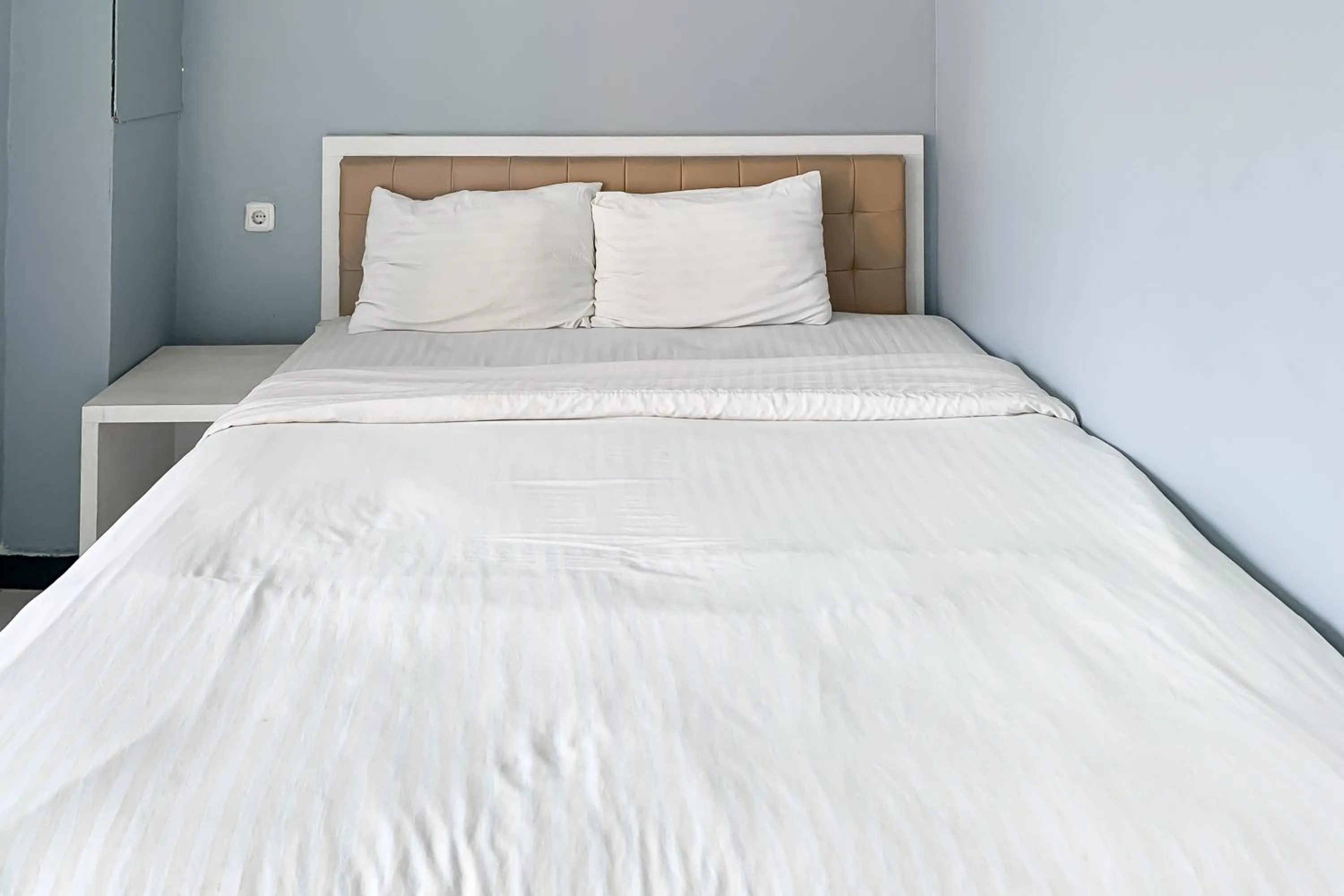 Bed in Karins Guesthouse Syariah RedPartner