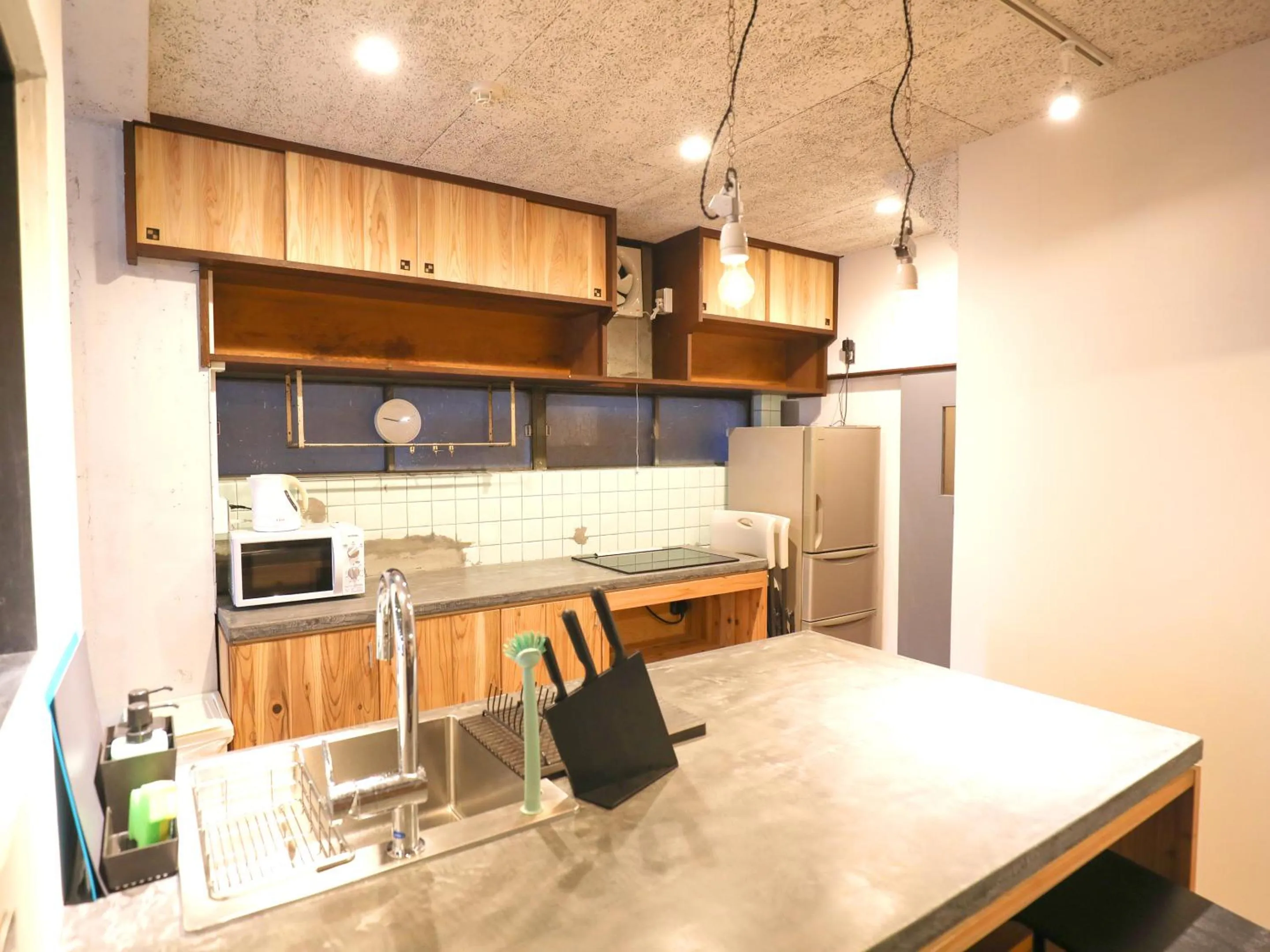 Communal kitchen in chAho Hostel Nirasaki / Outdoor Base