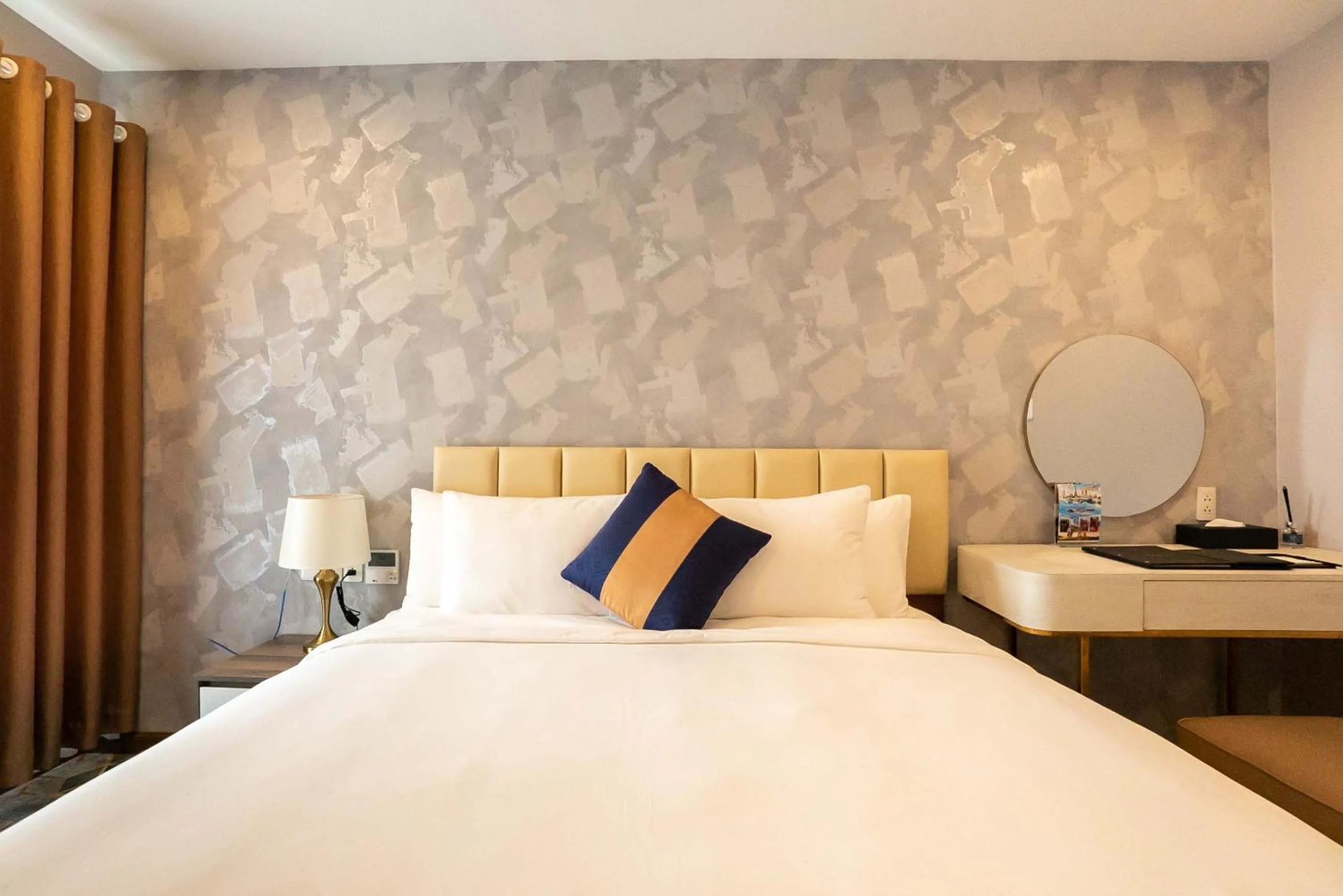 Bed in La Vela Saigon Hotel