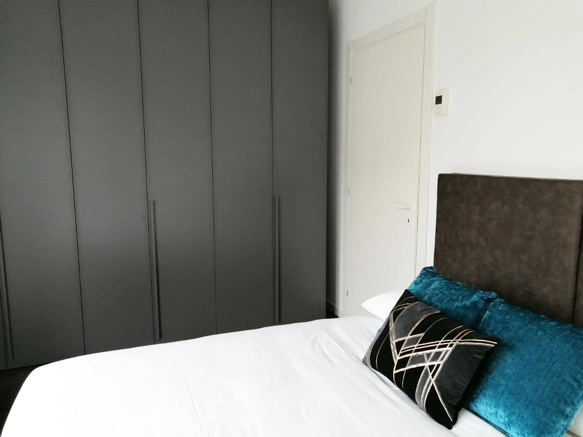 Bed in JOIVY Boutique Apartments Farneti