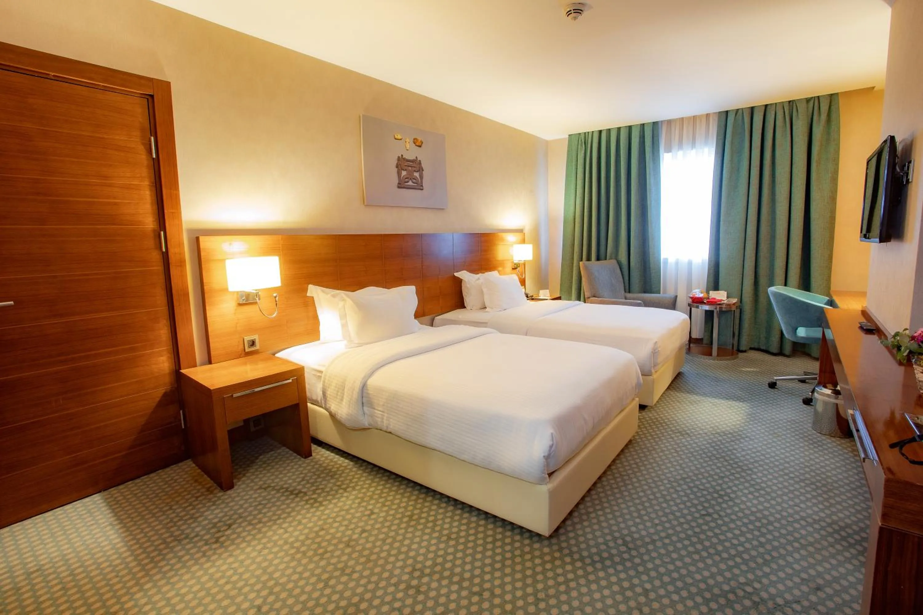 Communal lounge/ TV room, Bed in Nevali Hotel & Convention Center