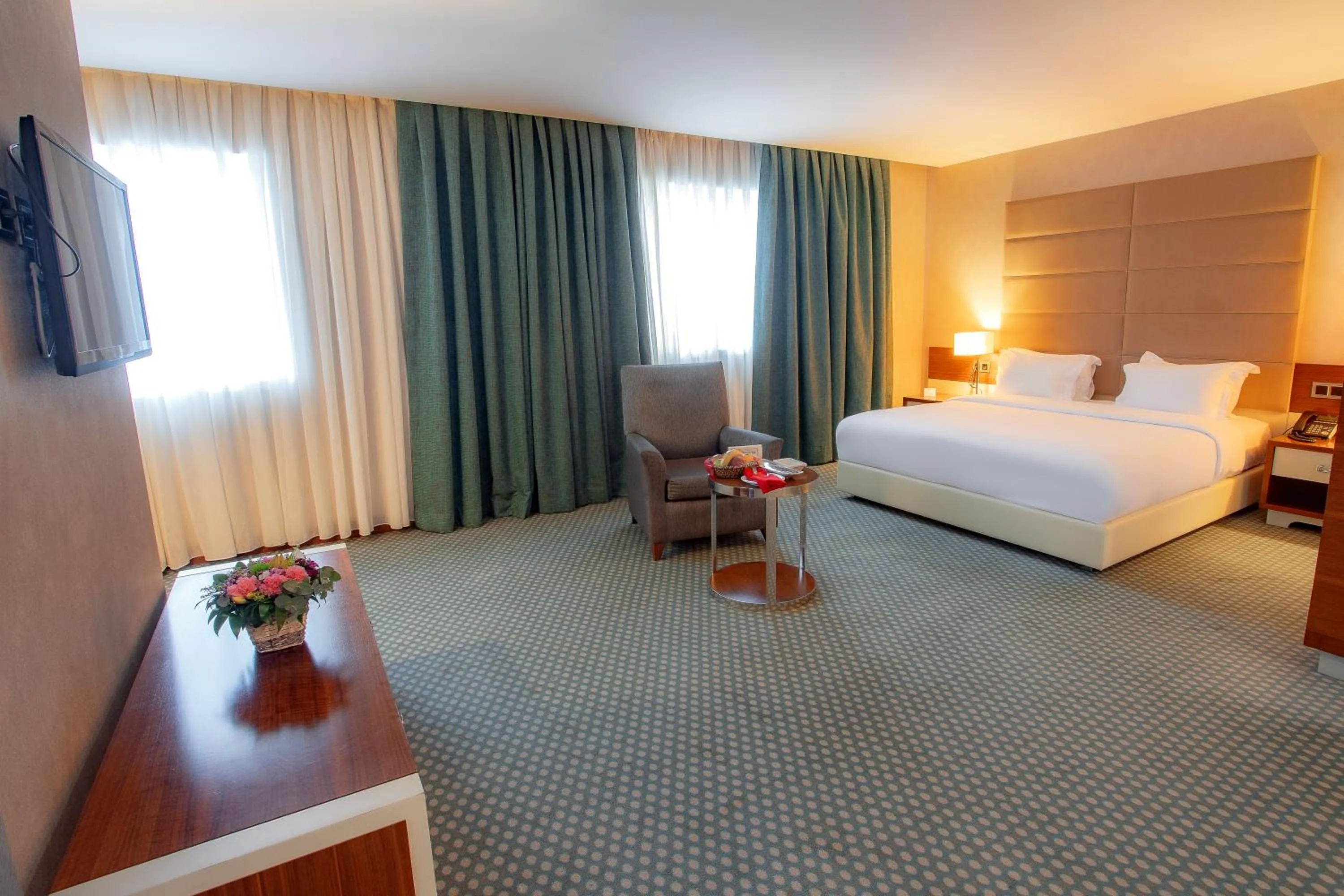 Communal lounge/ TV room, Bed in Nevali Hotel & Convention Center