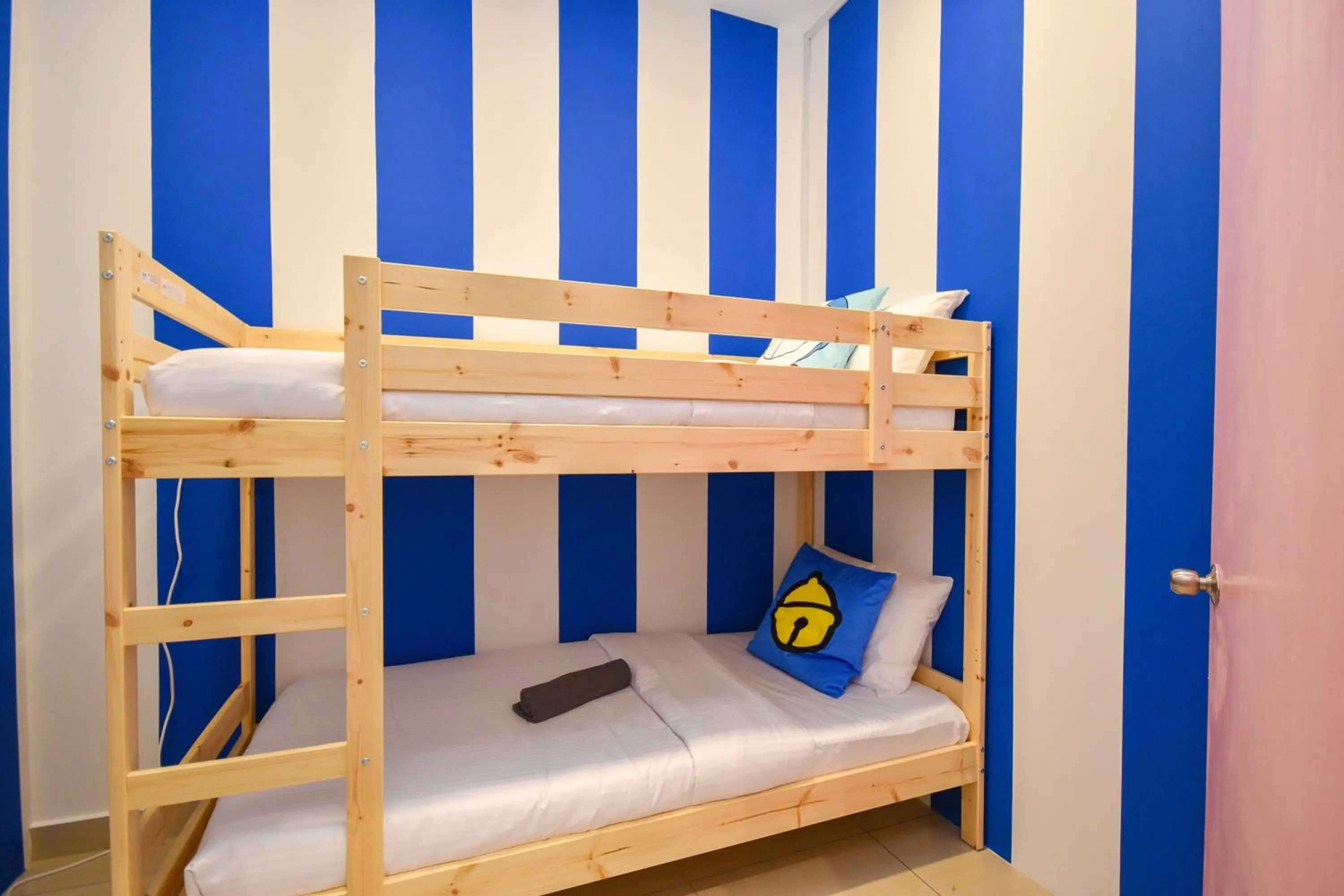 Bed in Manhattan Theme Suite by Nest Home at Austin Heights