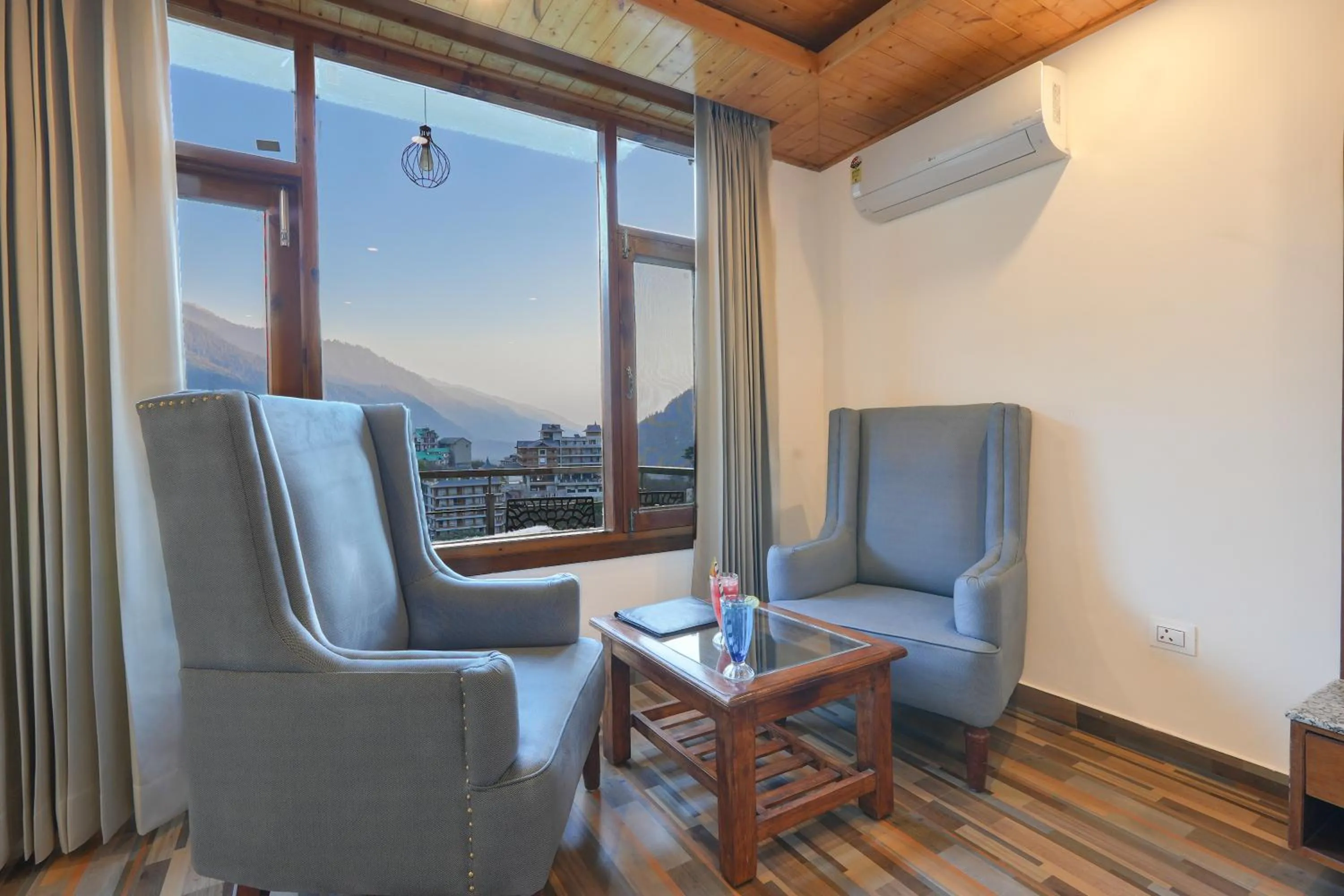 Seating area in Snow City's Montana Blues Resort Manali - Heated & Air-Cooled Stay