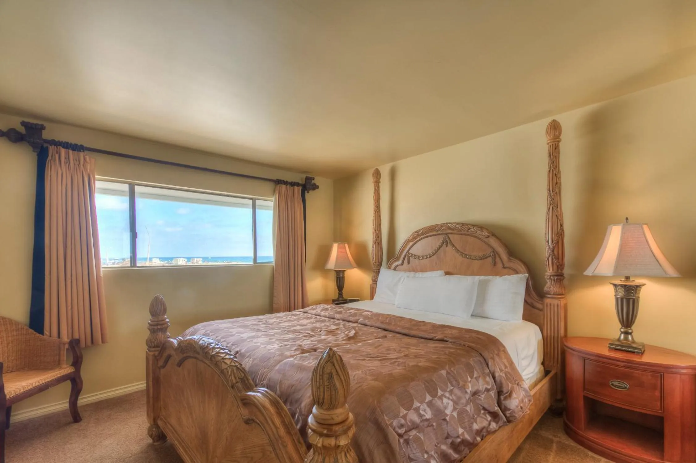 Bed in Oceanside Marina Suites - A Waterfront Hotel