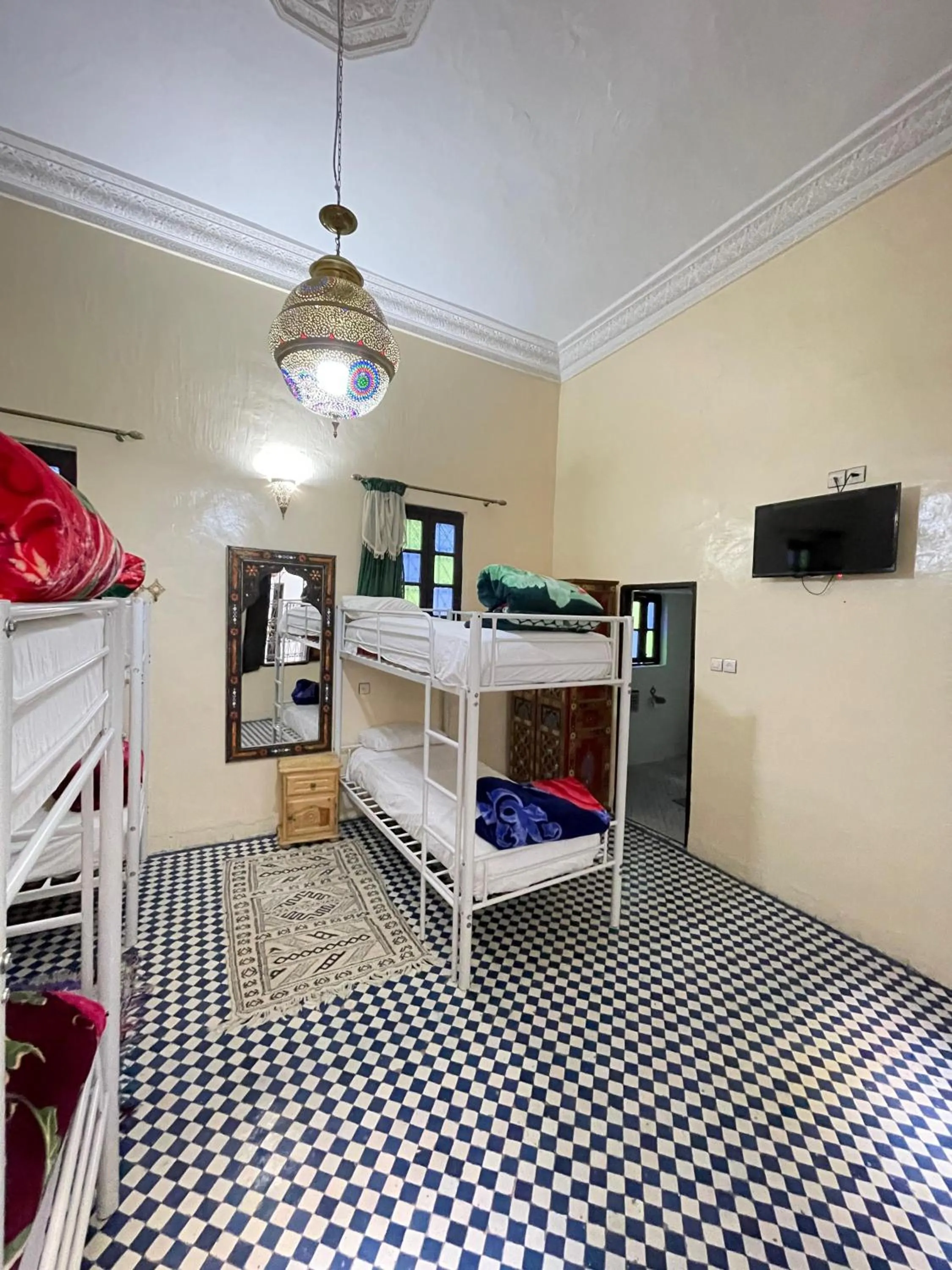 Communal lounge/ TV room, Bed in Dar Atlantic