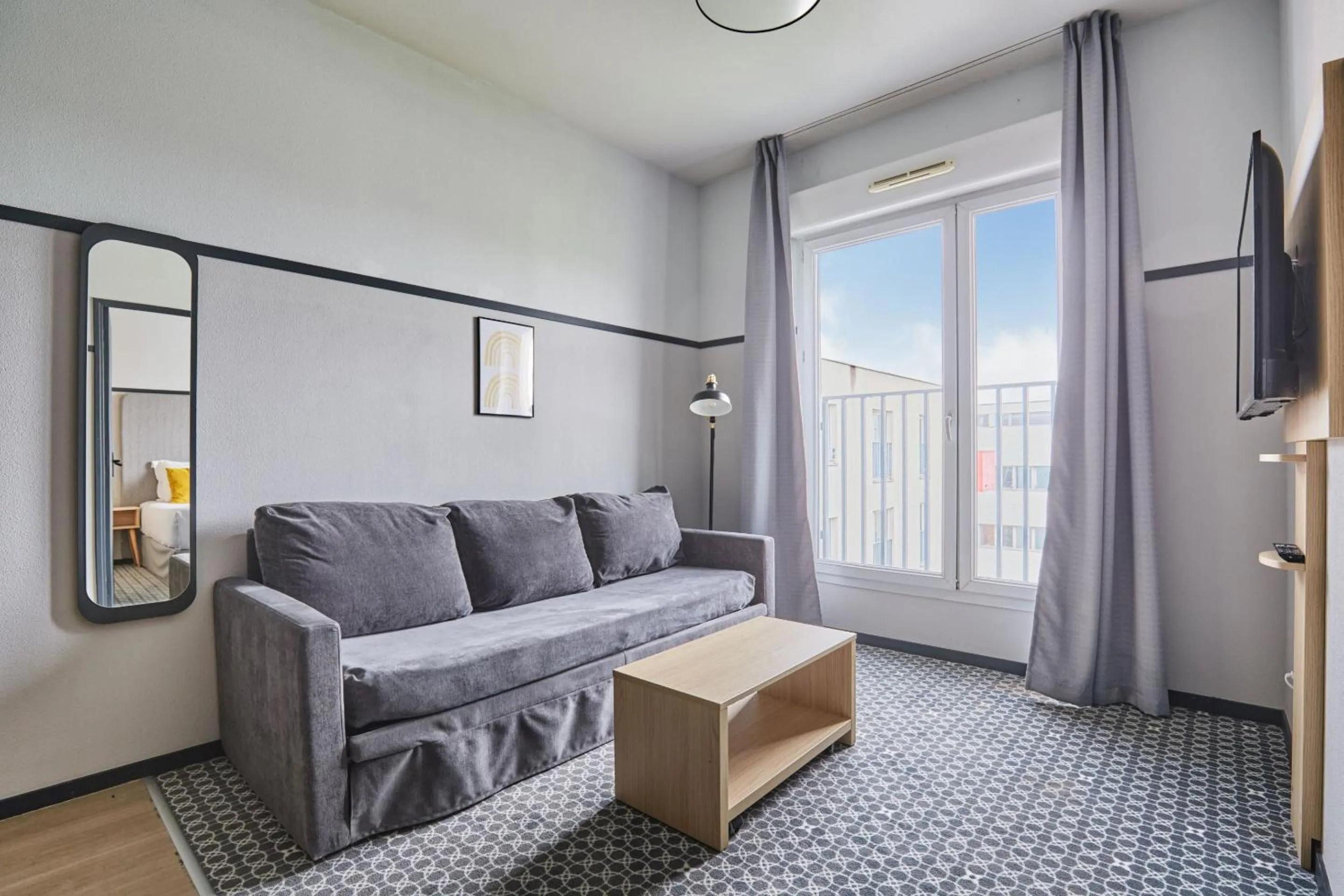 Living room in Appart'hôtel Odalys City - Bioparc Lyon Est