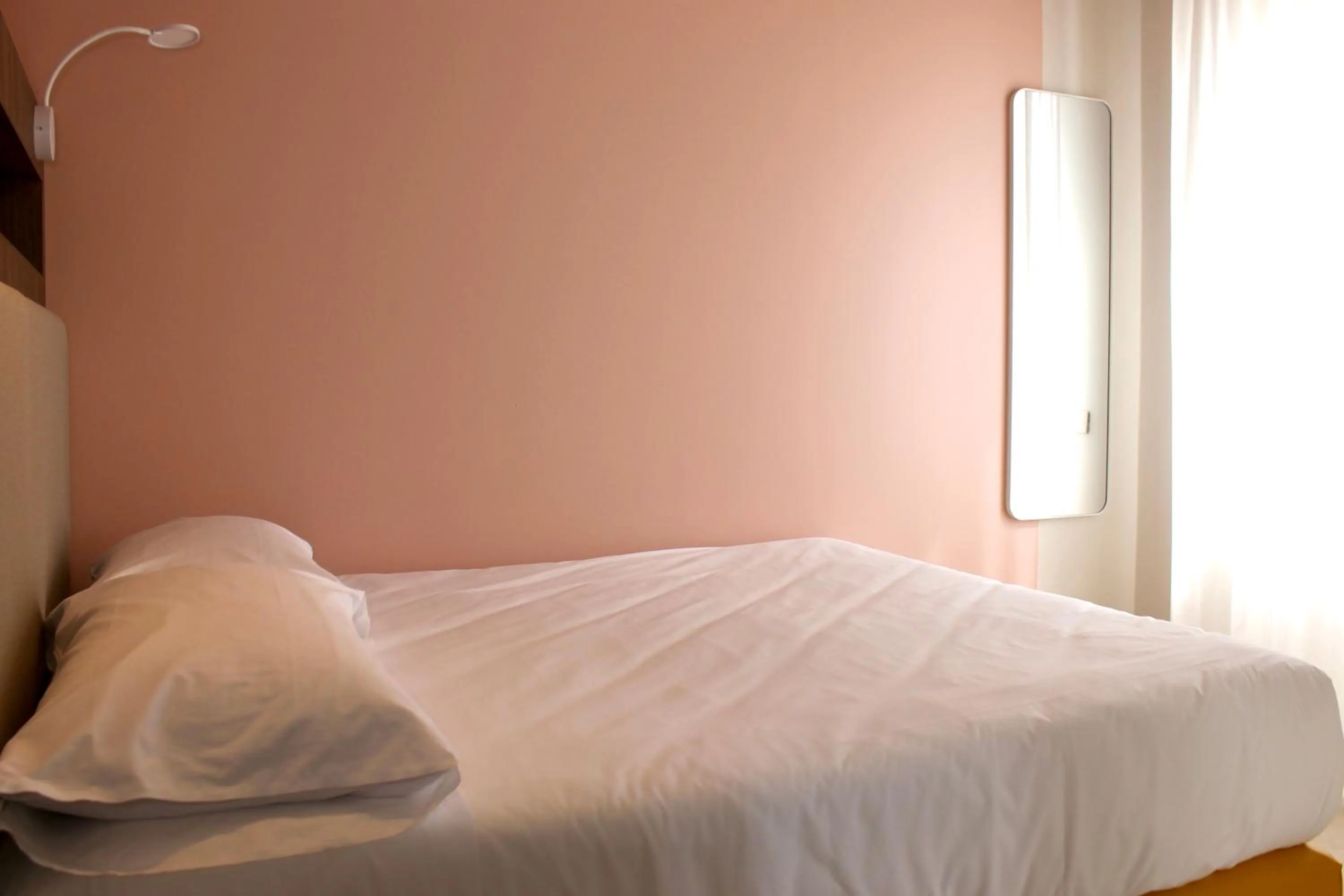 Bed in La Vista Postcard Hotel