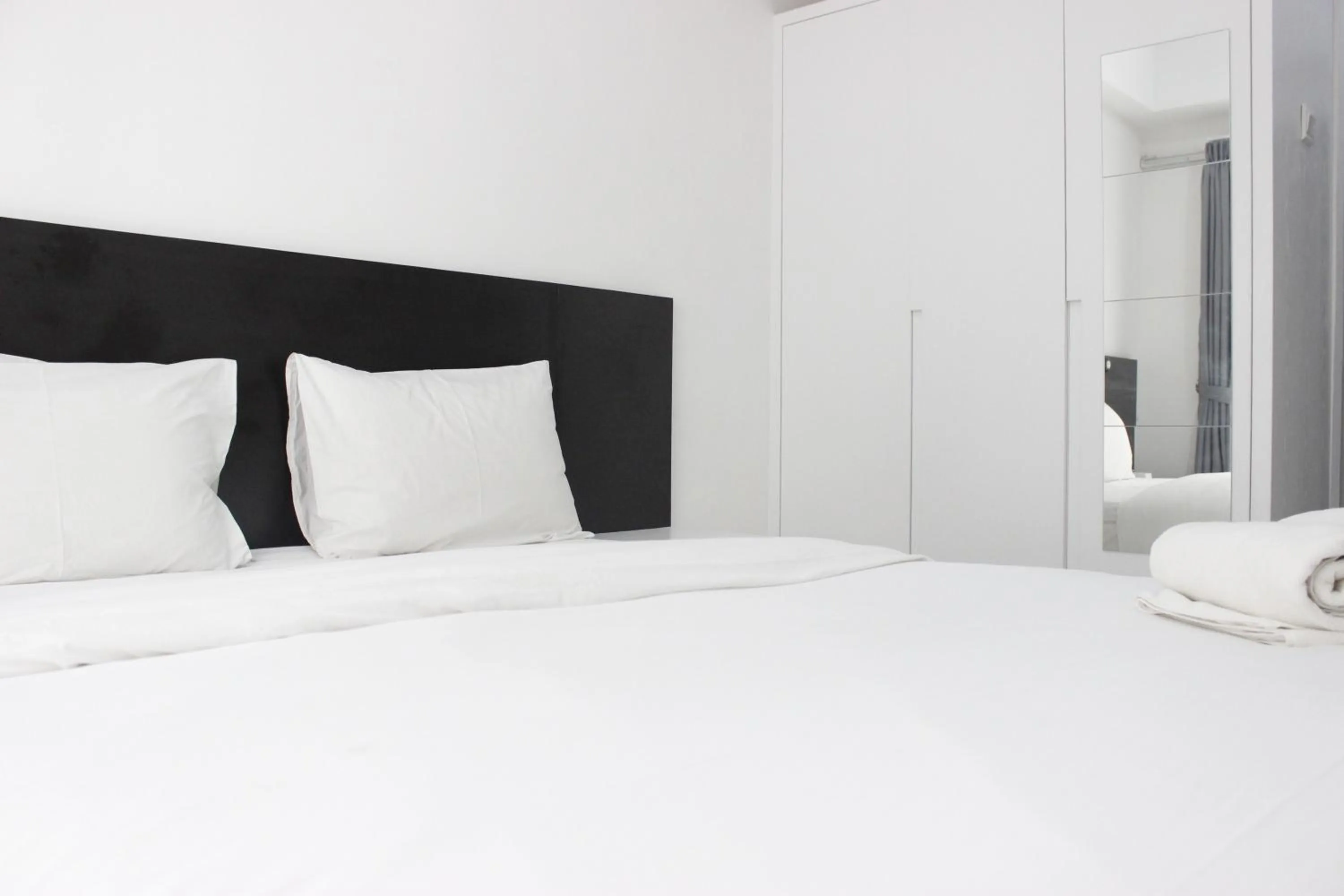 Bed in Monochrome Style Studio Room @Grand Asia Afrika Apartment By Travelio