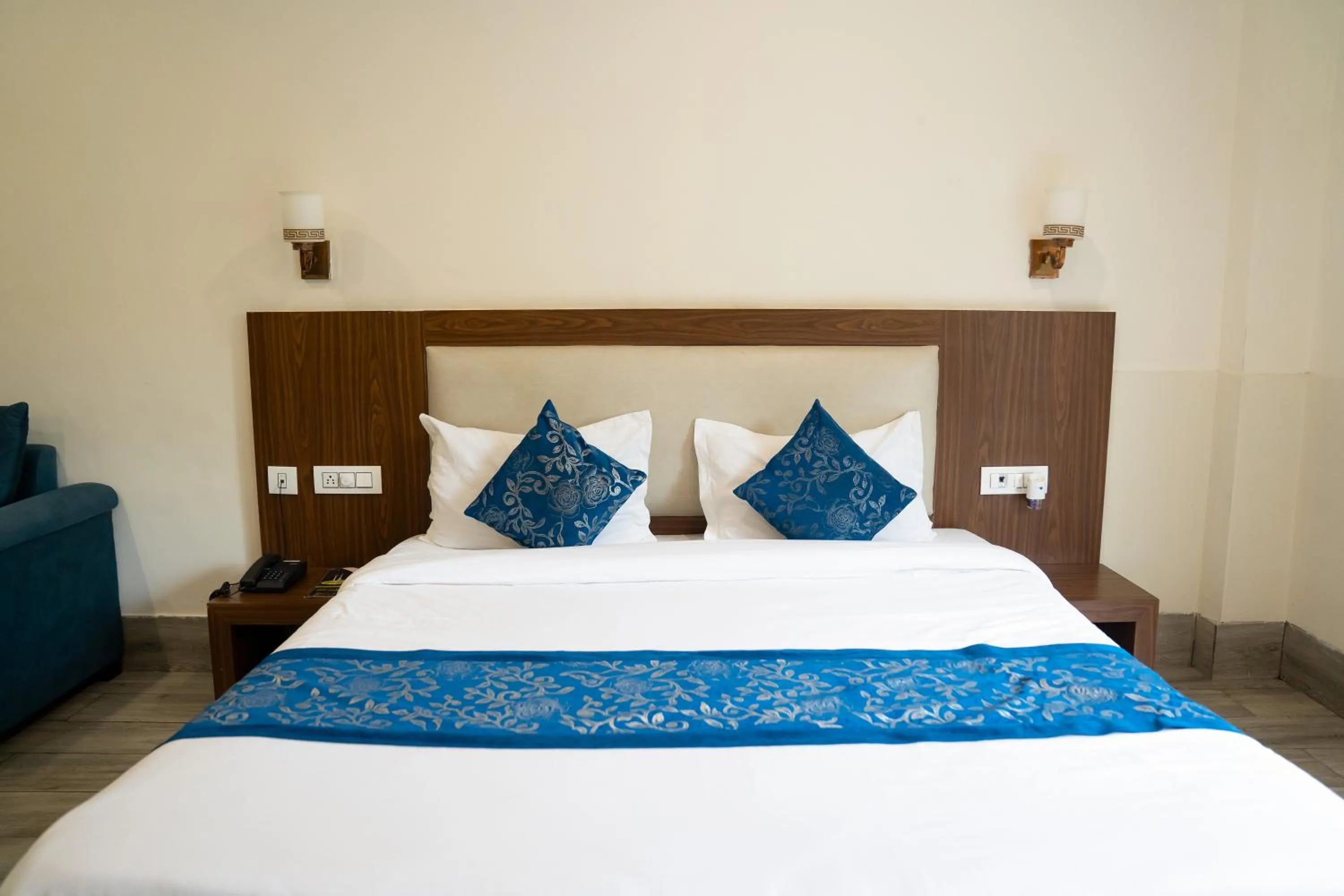 Bed in Vrinda Anandam Resort