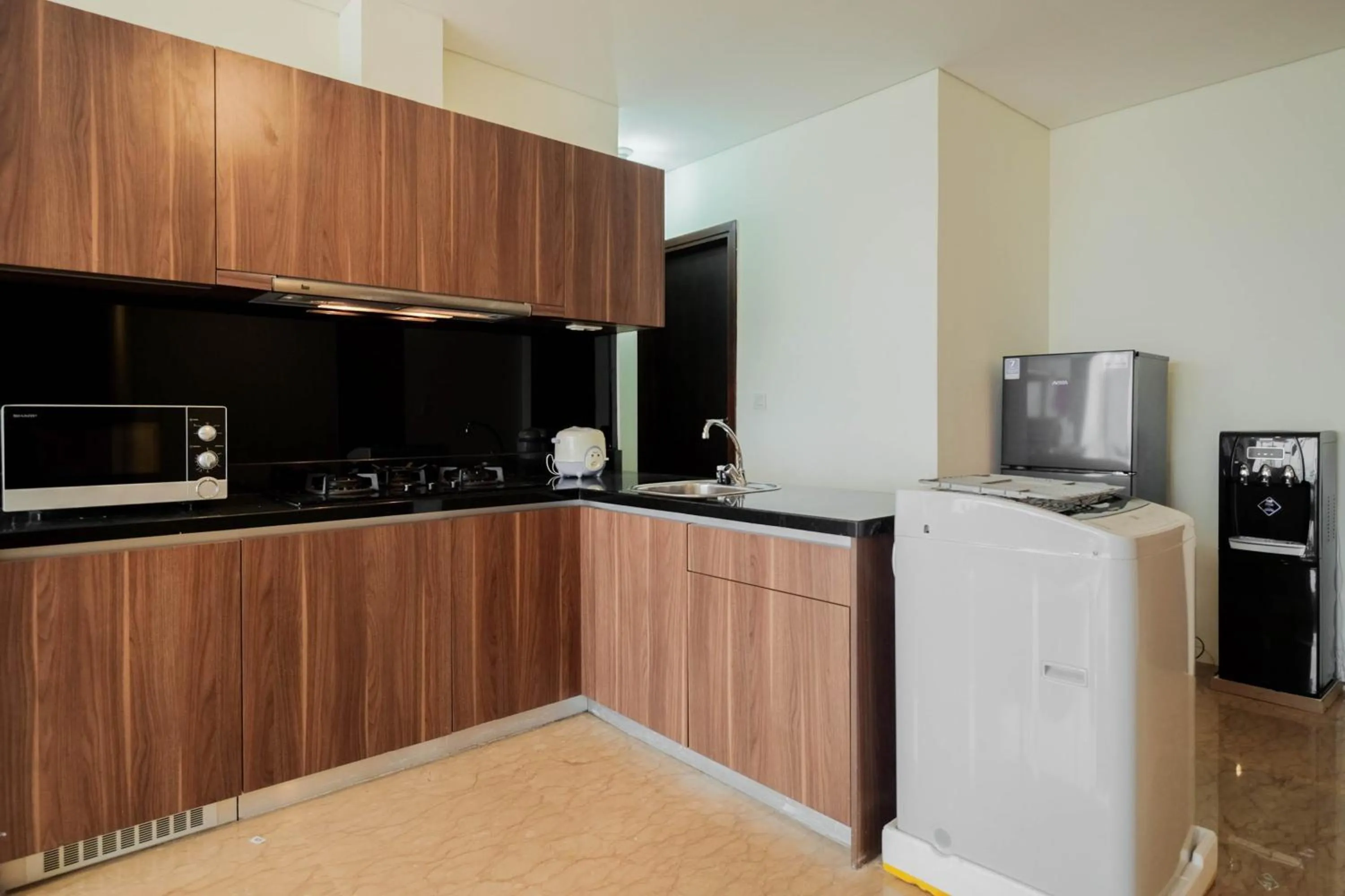 Kitchen or kitchenette in Comfy 3BR at L'Avenue Apartment Pancoran By Travelio