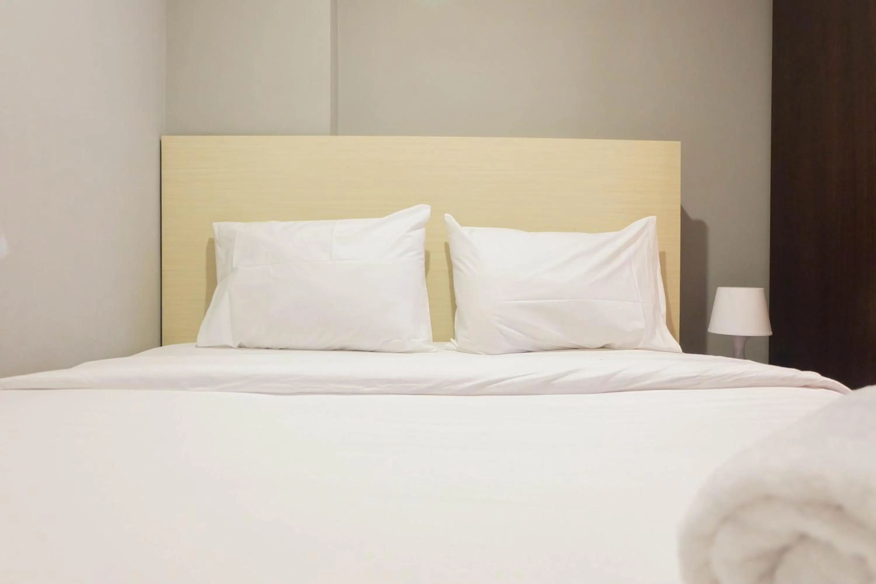 Bed in Exclusive and Spacious 1BR Apartment at Bassura City By Travelio