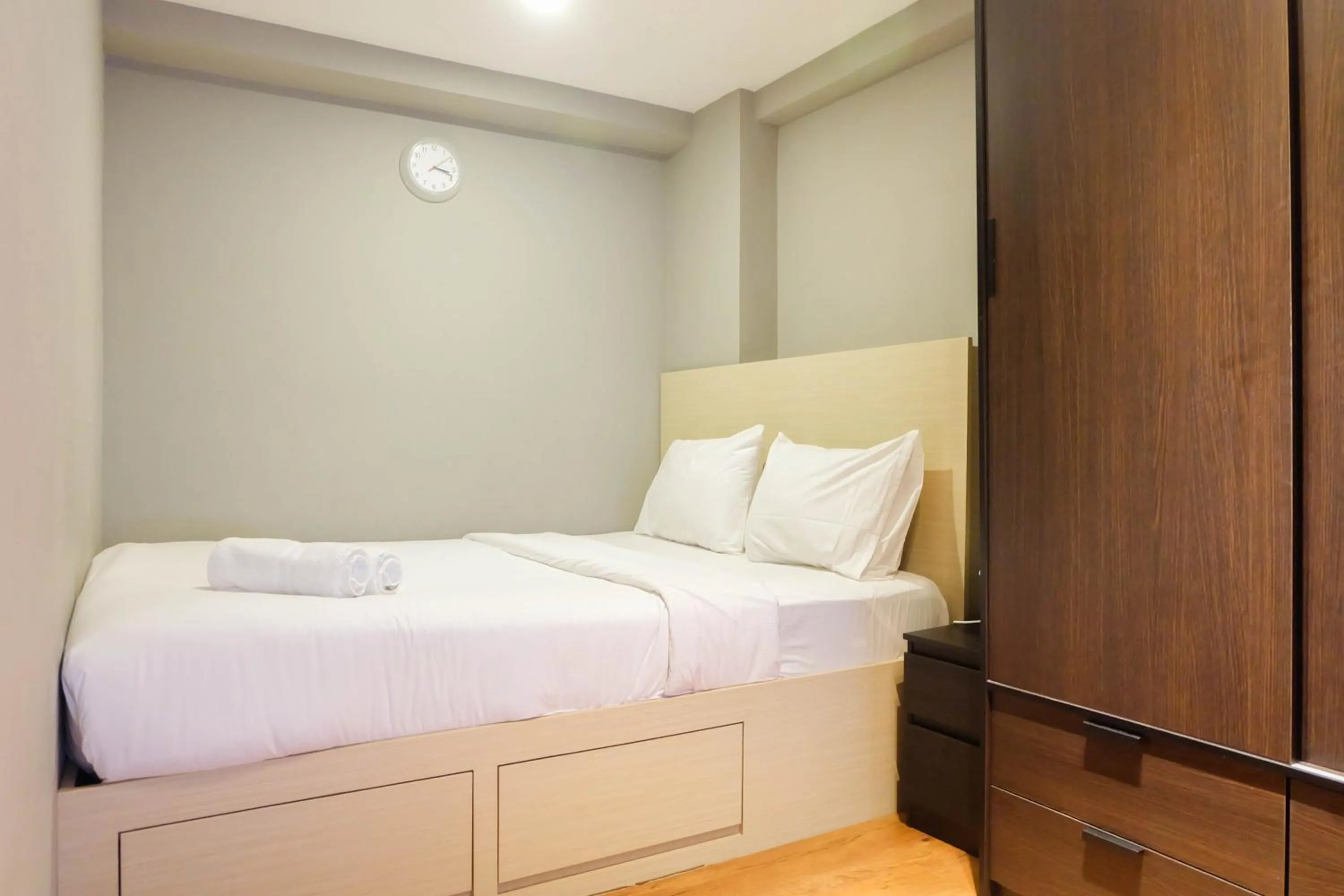 Bed in Exclusive and Spacious 1BR Apartment at Bassura City By Travelio