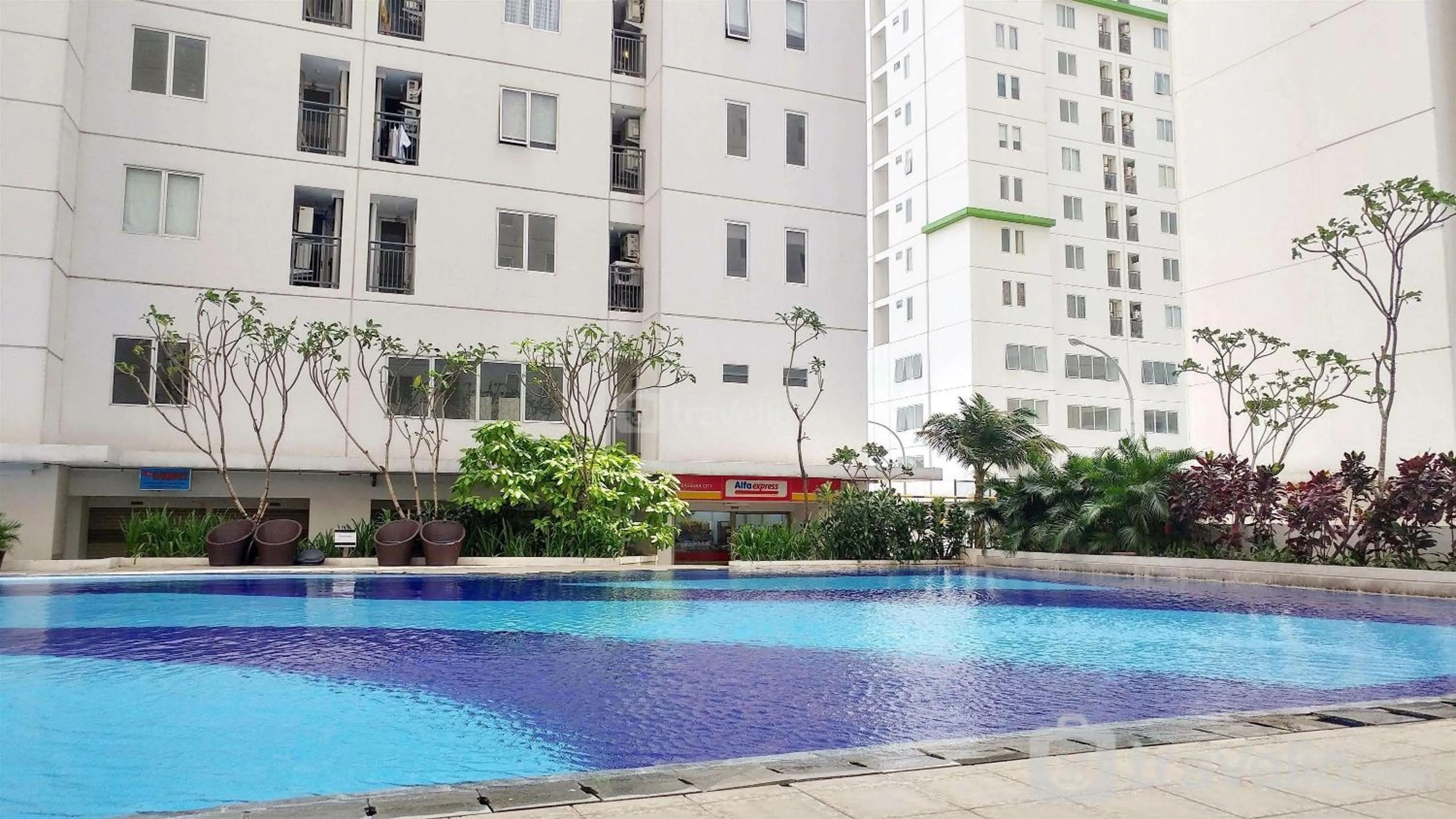 Bed in Exclusive and Spacious 1BR Apartment at Bassura City By Travelio