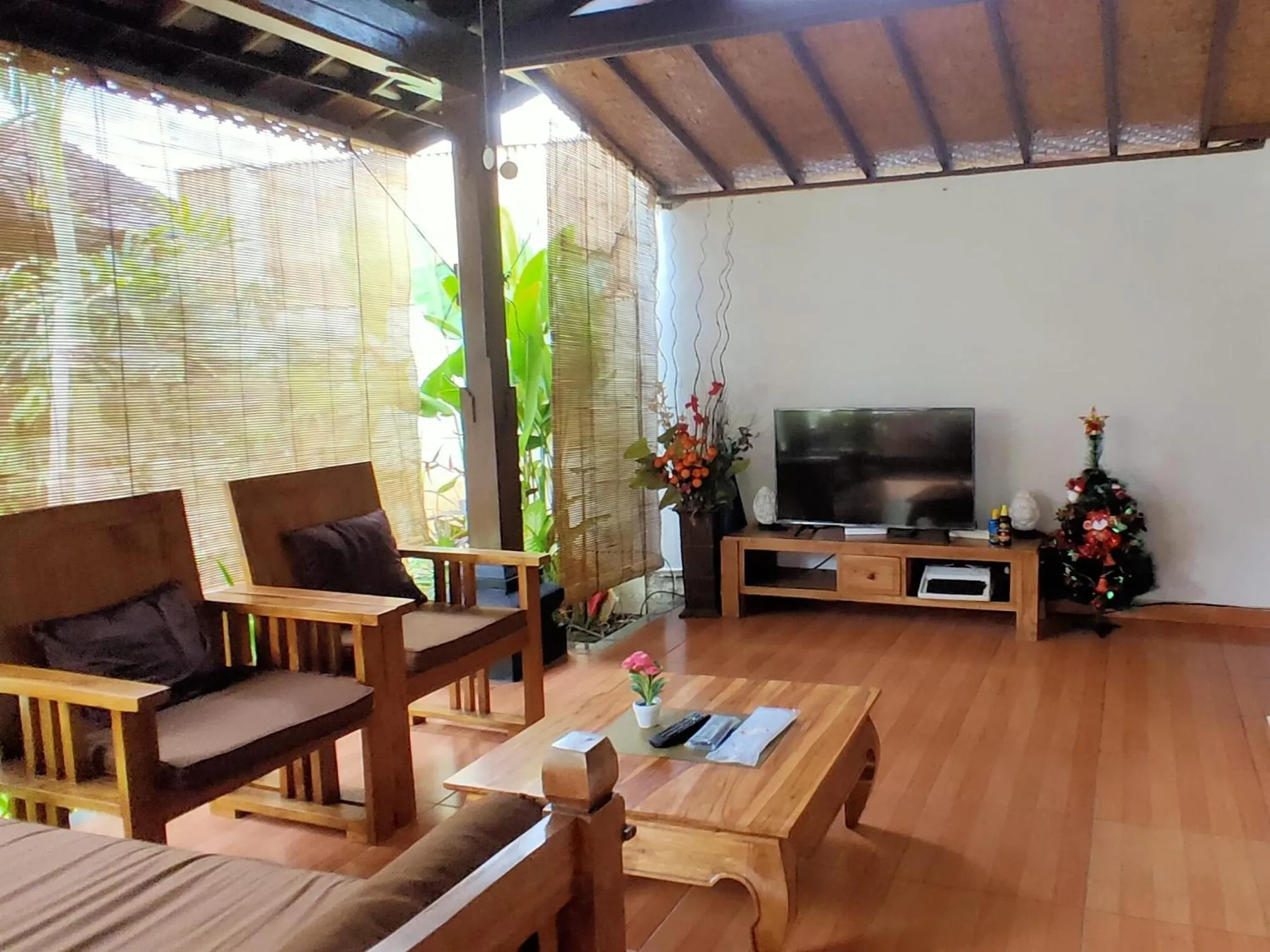 Communal lounge/ TV room in Tegal Uma Seminyak by Maha Bali