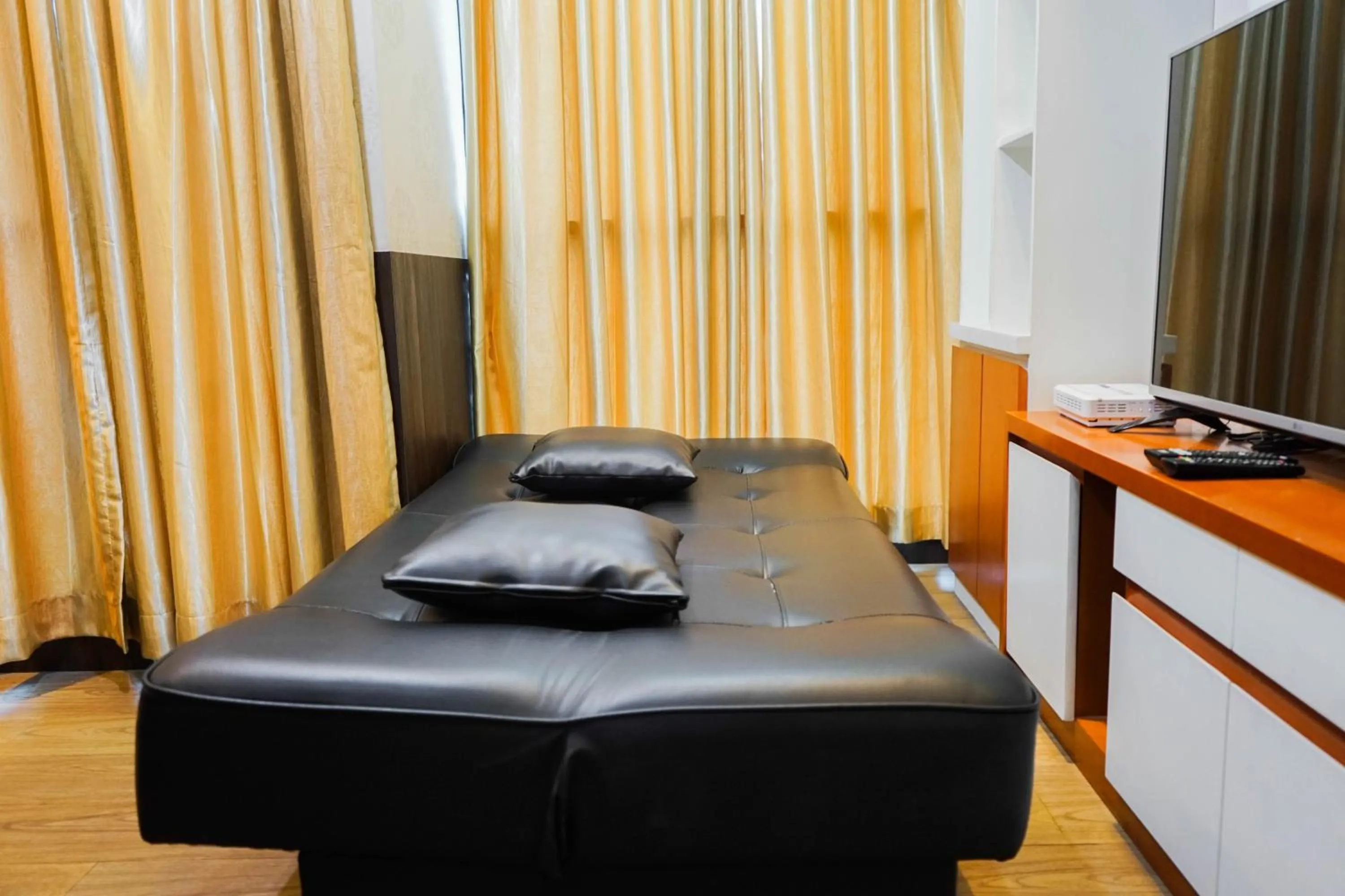 Living room, Bed in Best Price 2BR at Tifolia Apartment By Travelio