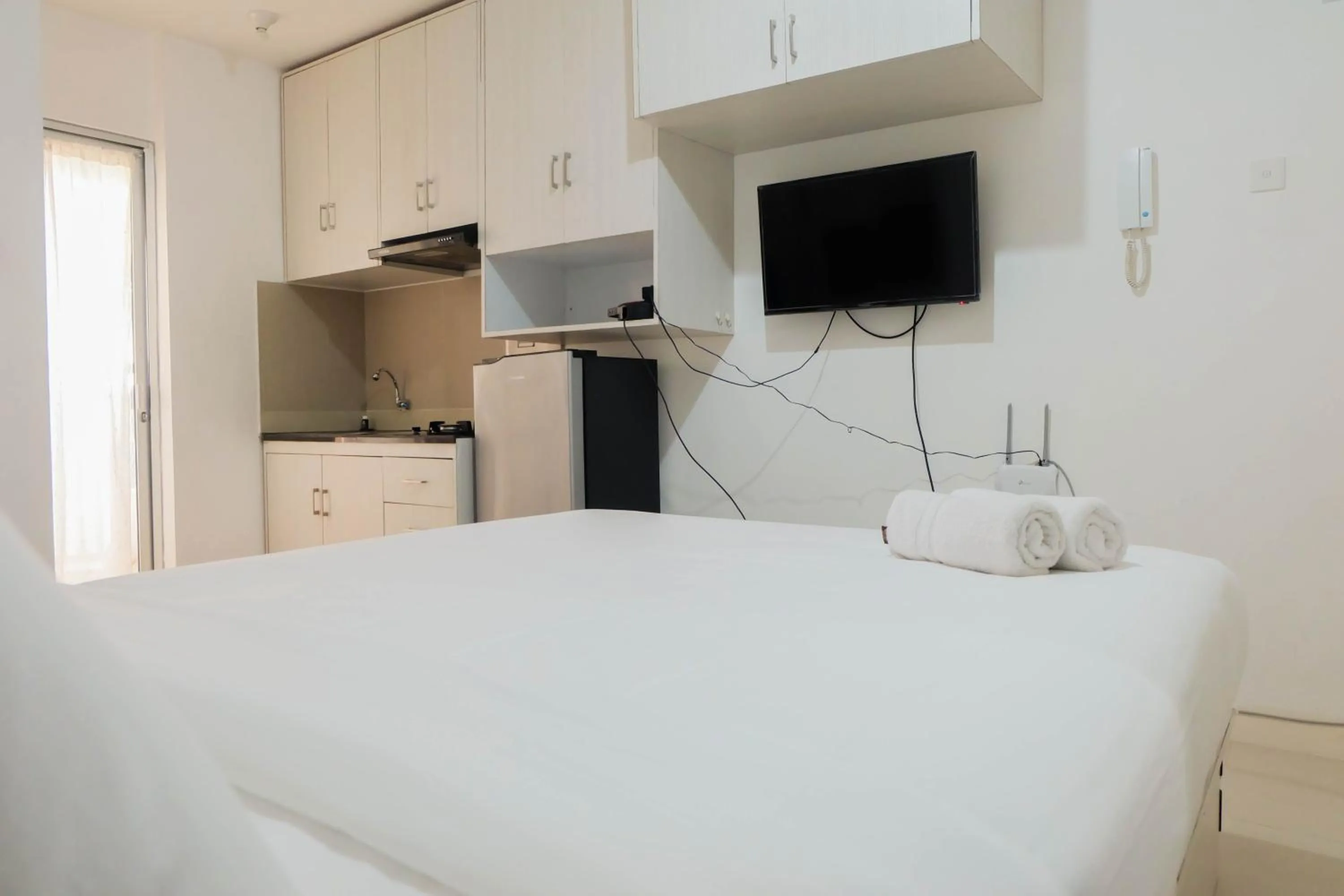 Bed in Tidy Studio Apartment at Bassura City near Shopping Mall By Travelio