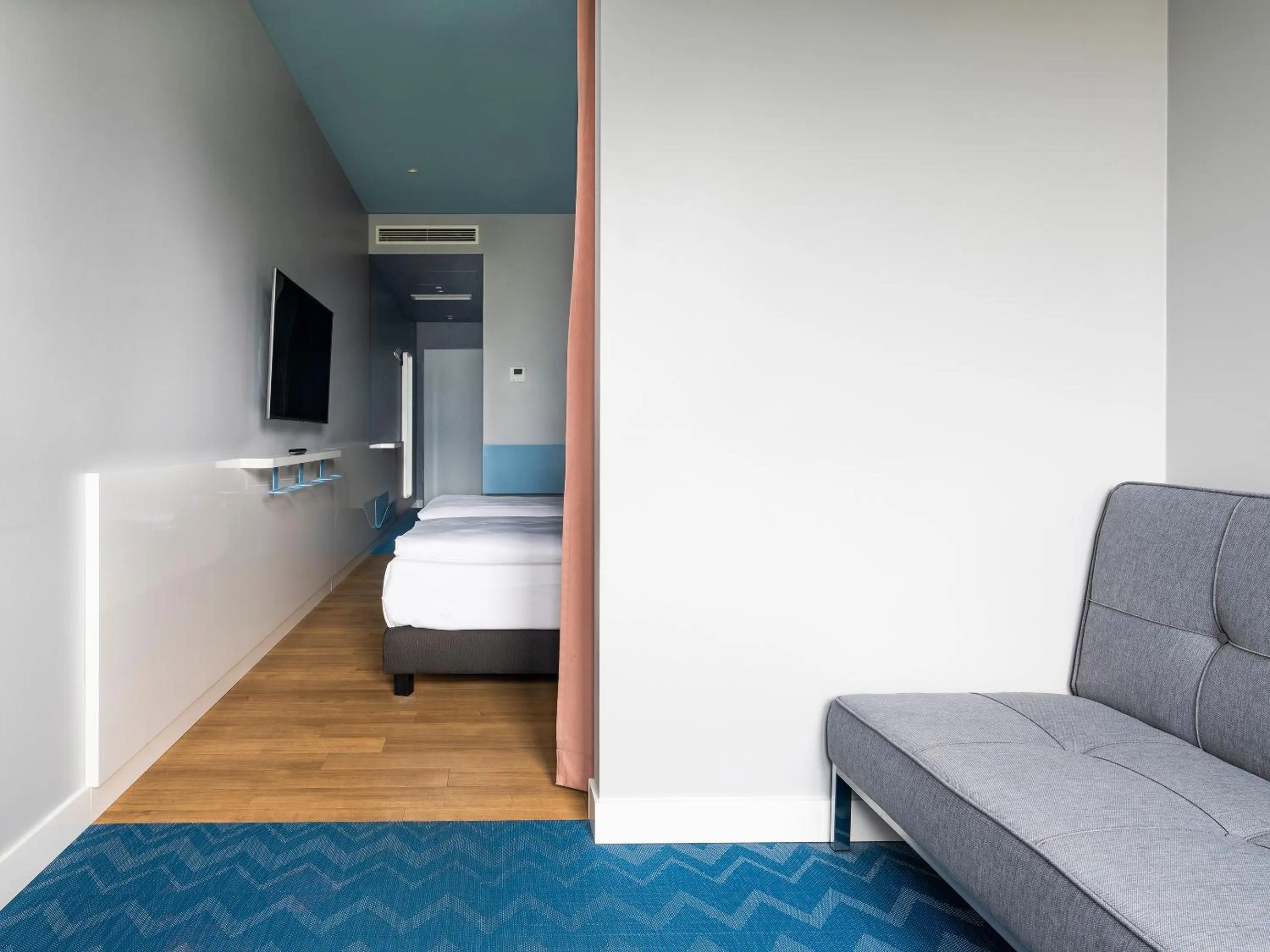 Seating area, Bed in about:berlin Hotel