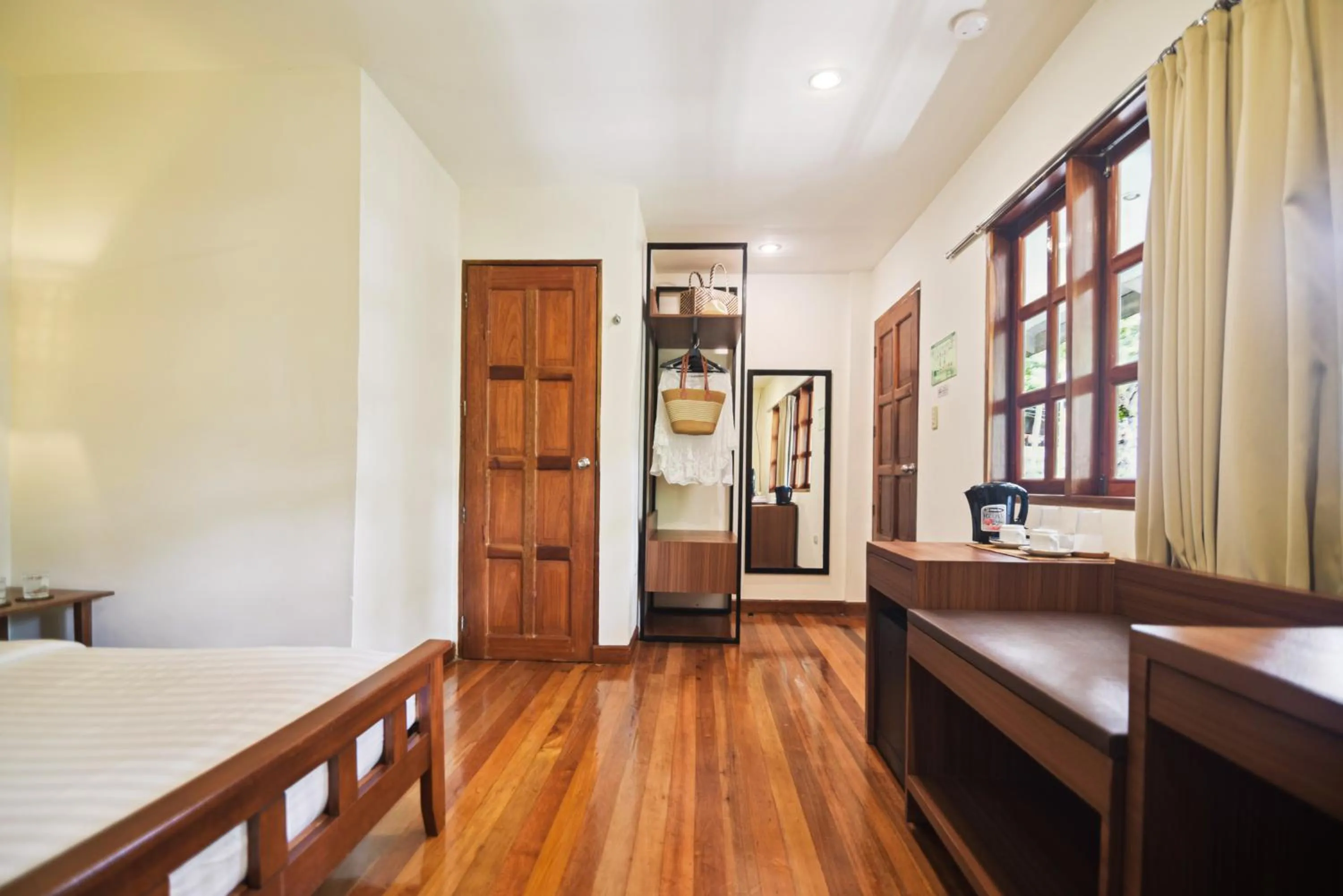 Bed in The Strand Boutique Resort