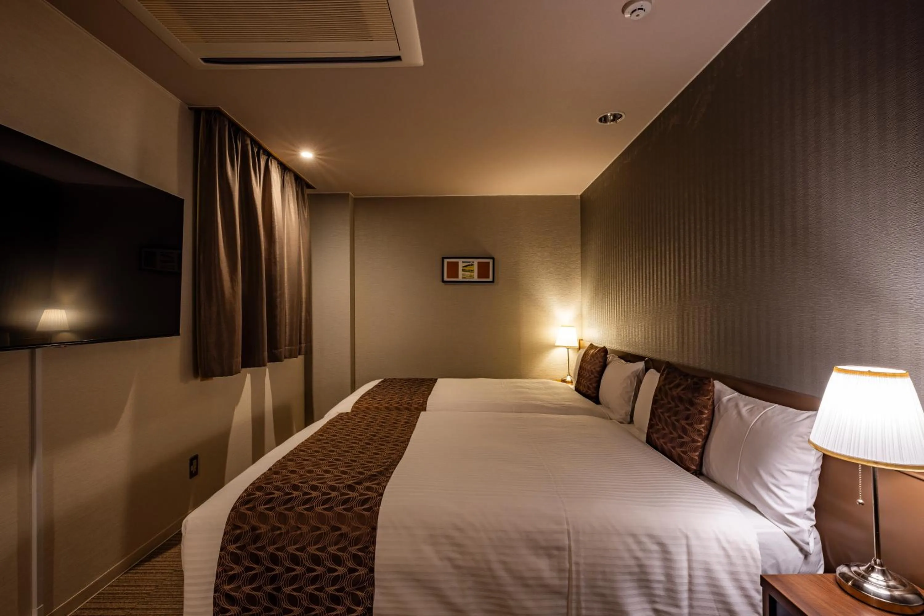 Bed in Hotel Quest Shimizu