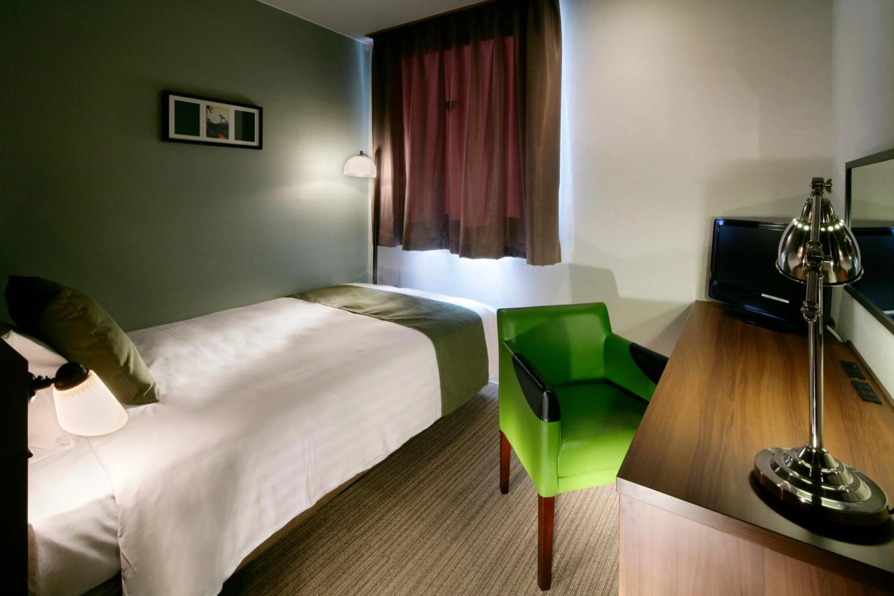 Bed in Hotel Quest Shimizu