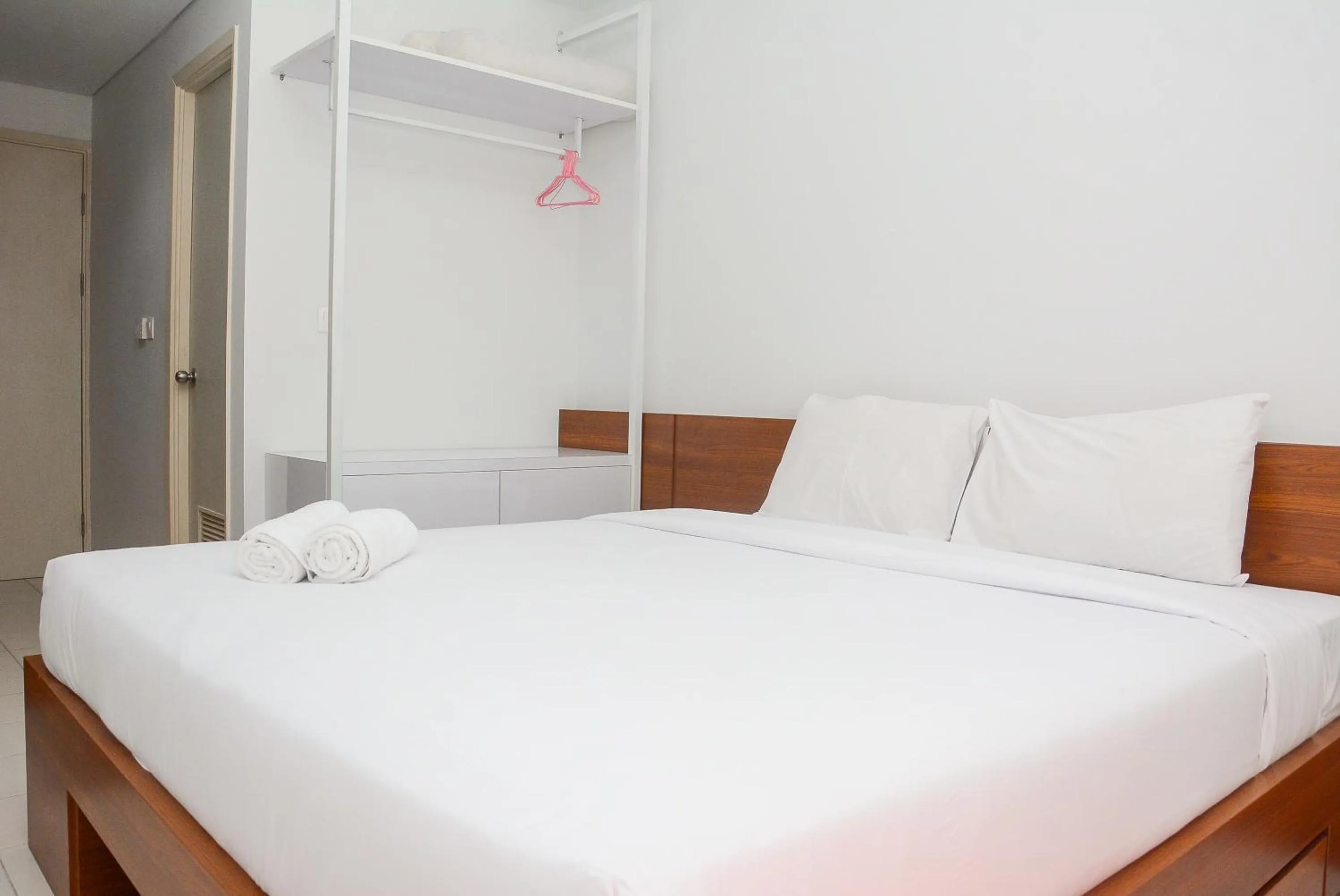 Bed in Comfy Studio Room at Patraland Urbano Apartment By Travelio