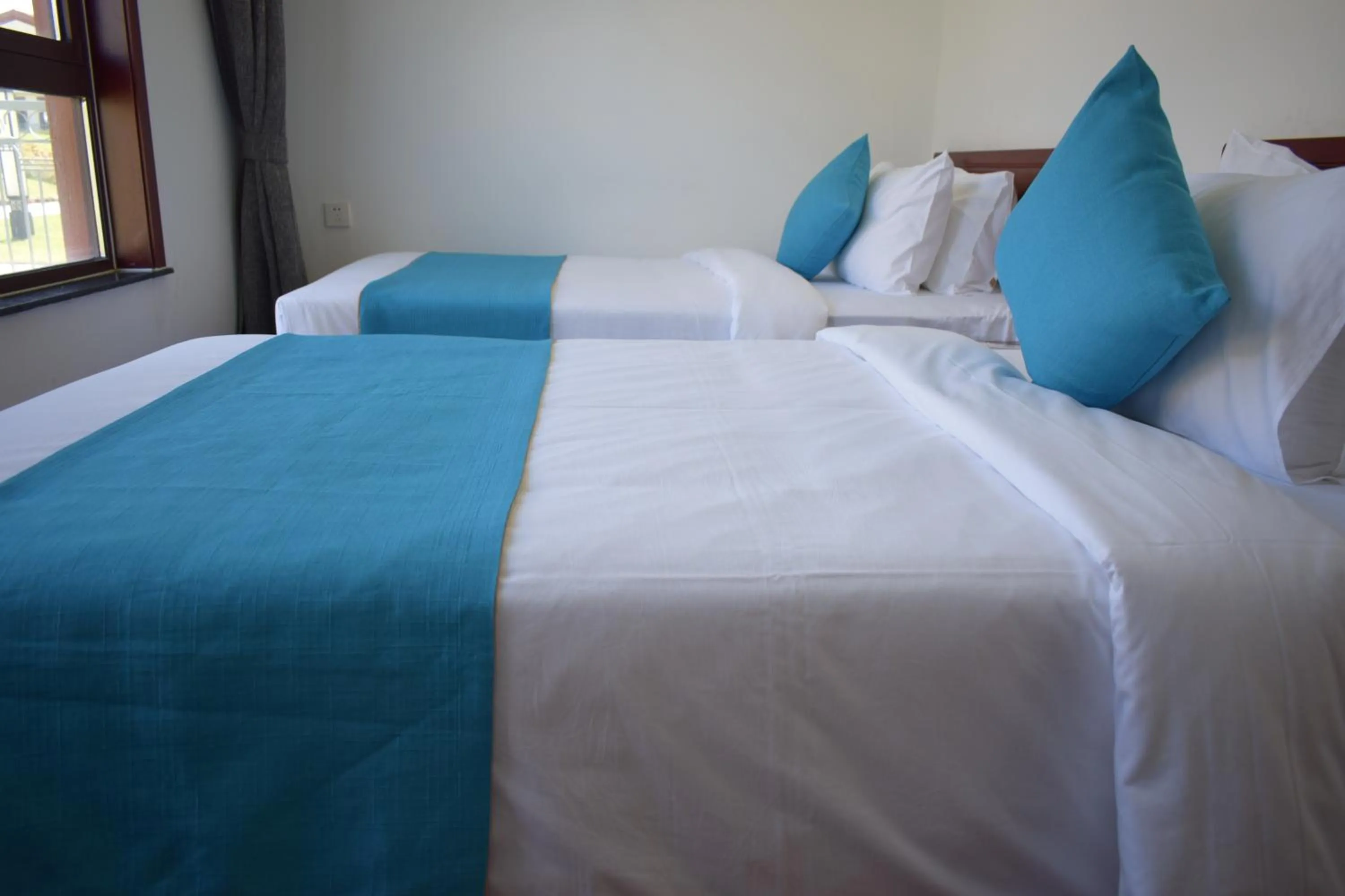 Bed in Sealong Bay ZhongQi Conifer Hotel 海龙湾中启康年酒店